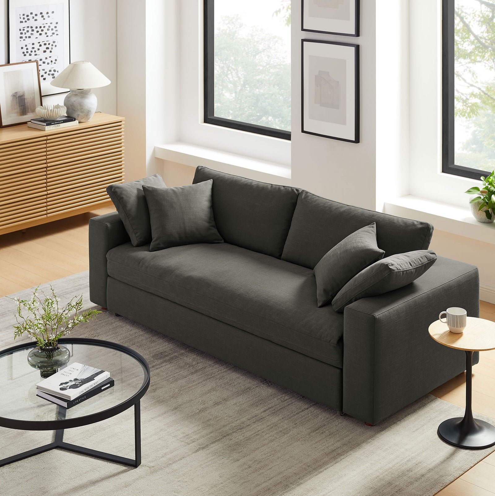 Gray Commix sleeper sofa anchoring a bright modern living room with layered neutral decor || EEI-7080-GRY || front_angle_room