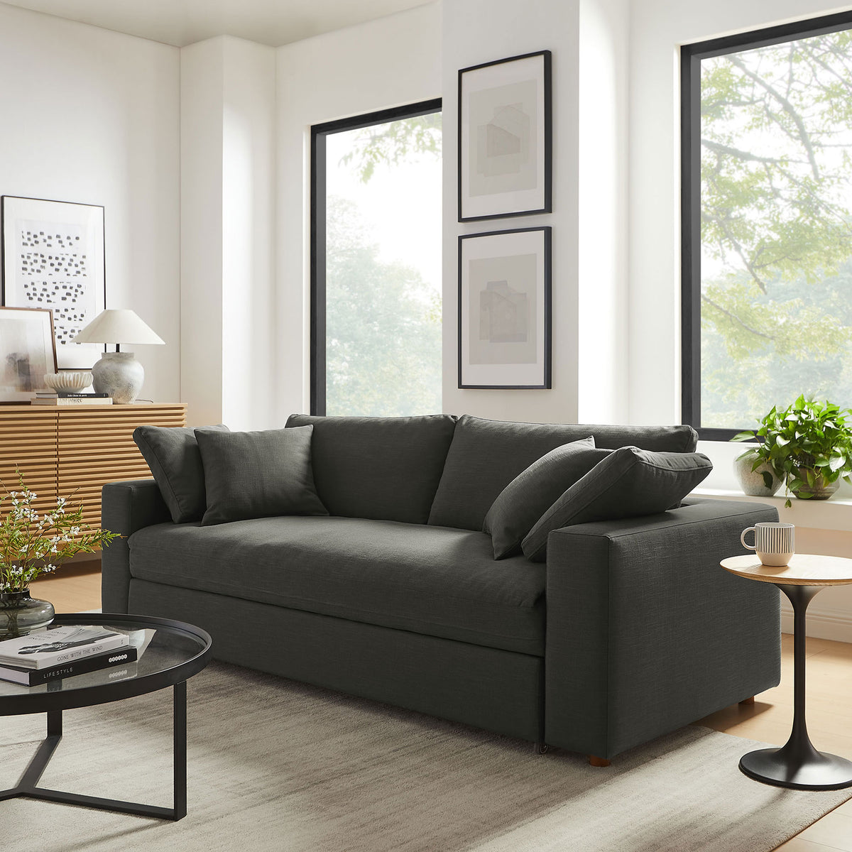 Overstuffed gray Commix sleeper sofa adding plush comfort to a sunlit living room || EEI-7080-GRY || front_angle_room