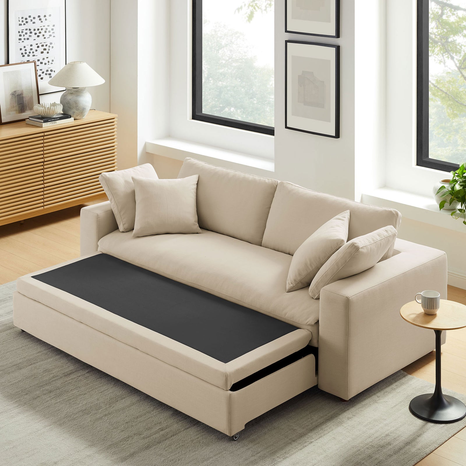 Living room scene showing the sleeper sofa with the convertible platform partially tucked away || EEI-7080-LBG || front_angle_converted_room