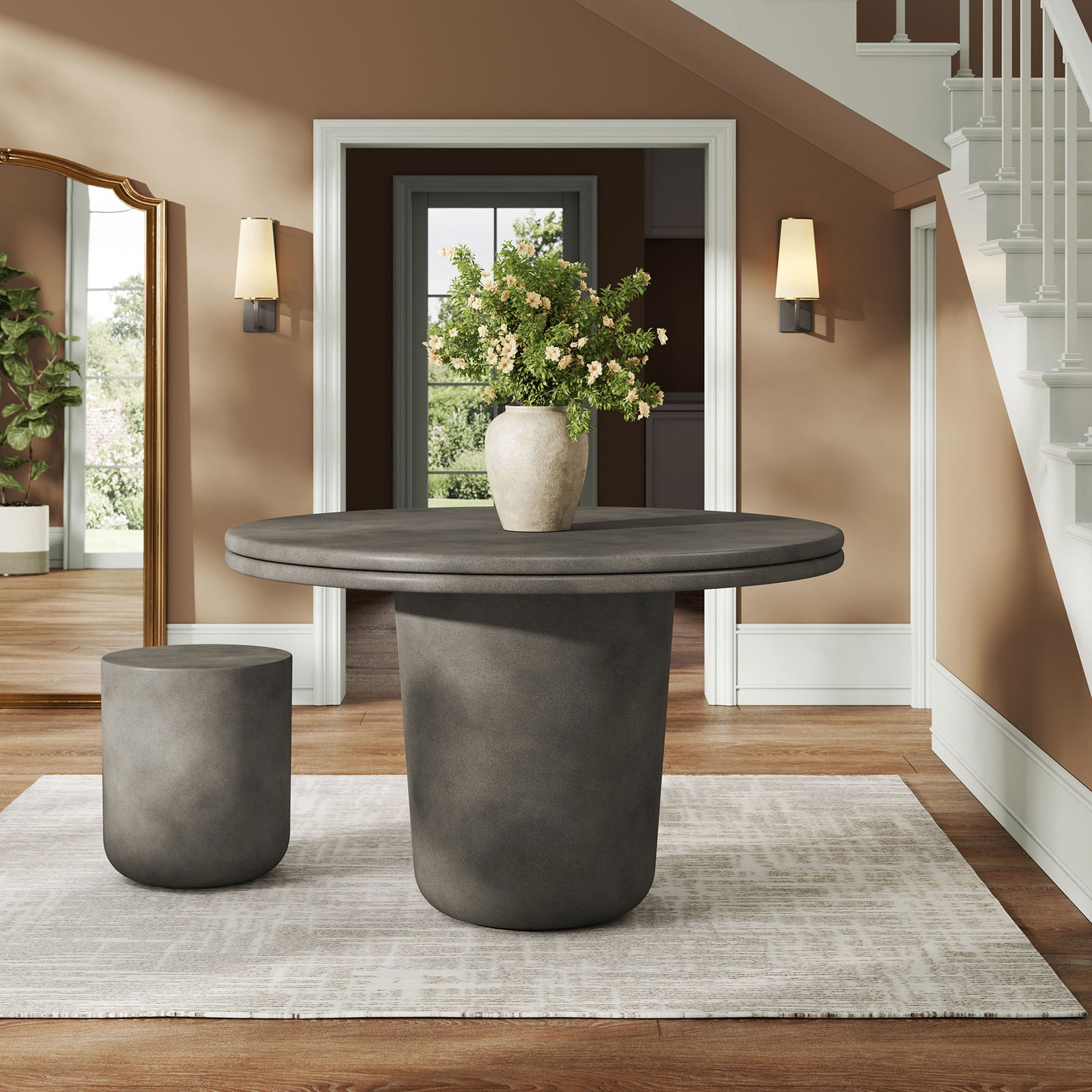 Gray concrete round dining table styled in an entryway with vase arrangement on neutral rug || EEI-7087-GRY || front_angle_room