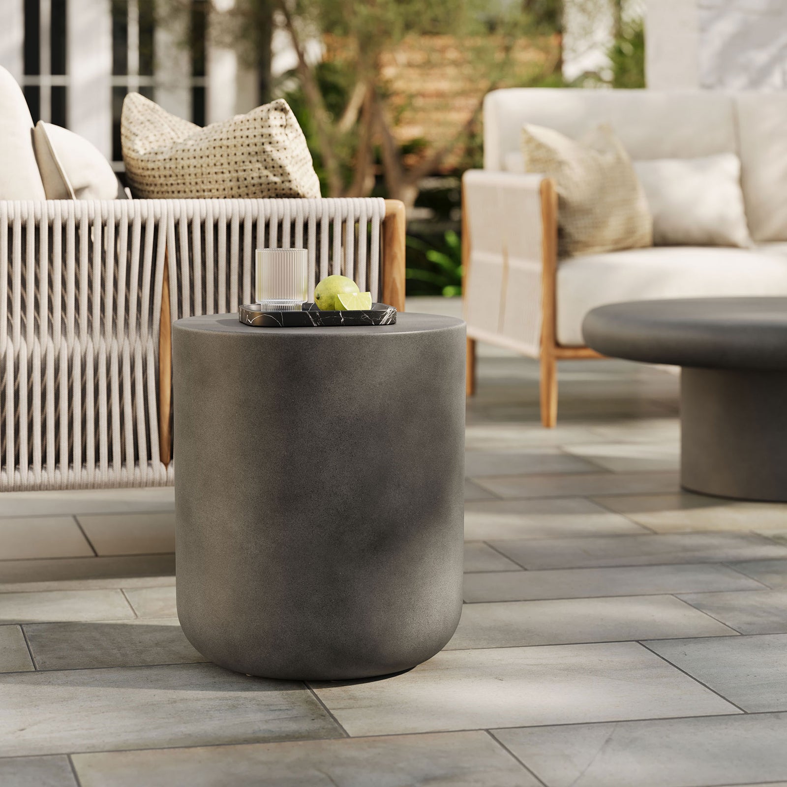 Brion gray concrete stool anchoring an outdoor seating area as a durable accent table or extra seat || EEI-7088-GRY || front_angle_room