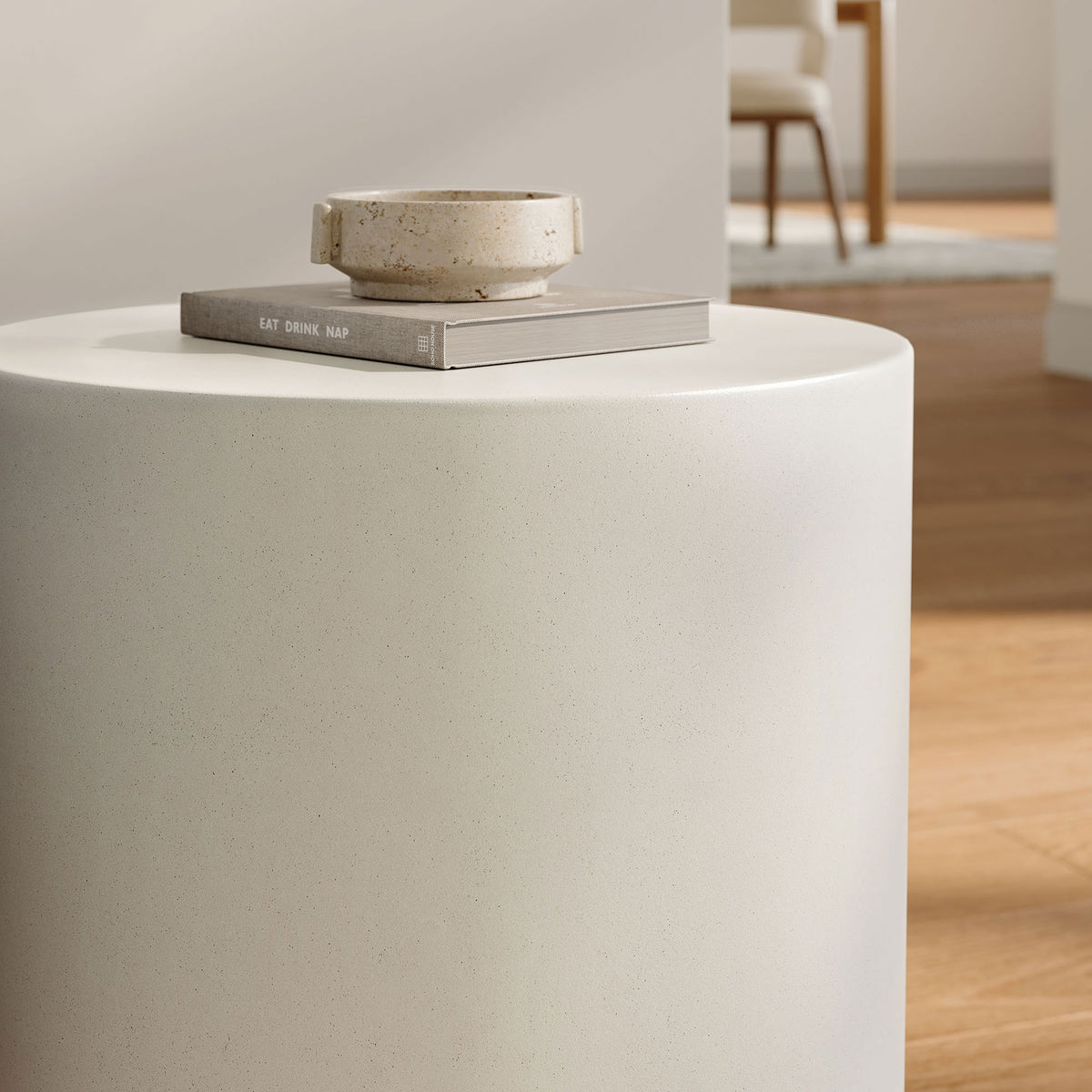 White concrete stool styled as a bright living room side table with book and bowl decor || EEI-7088-WHI || detail_room