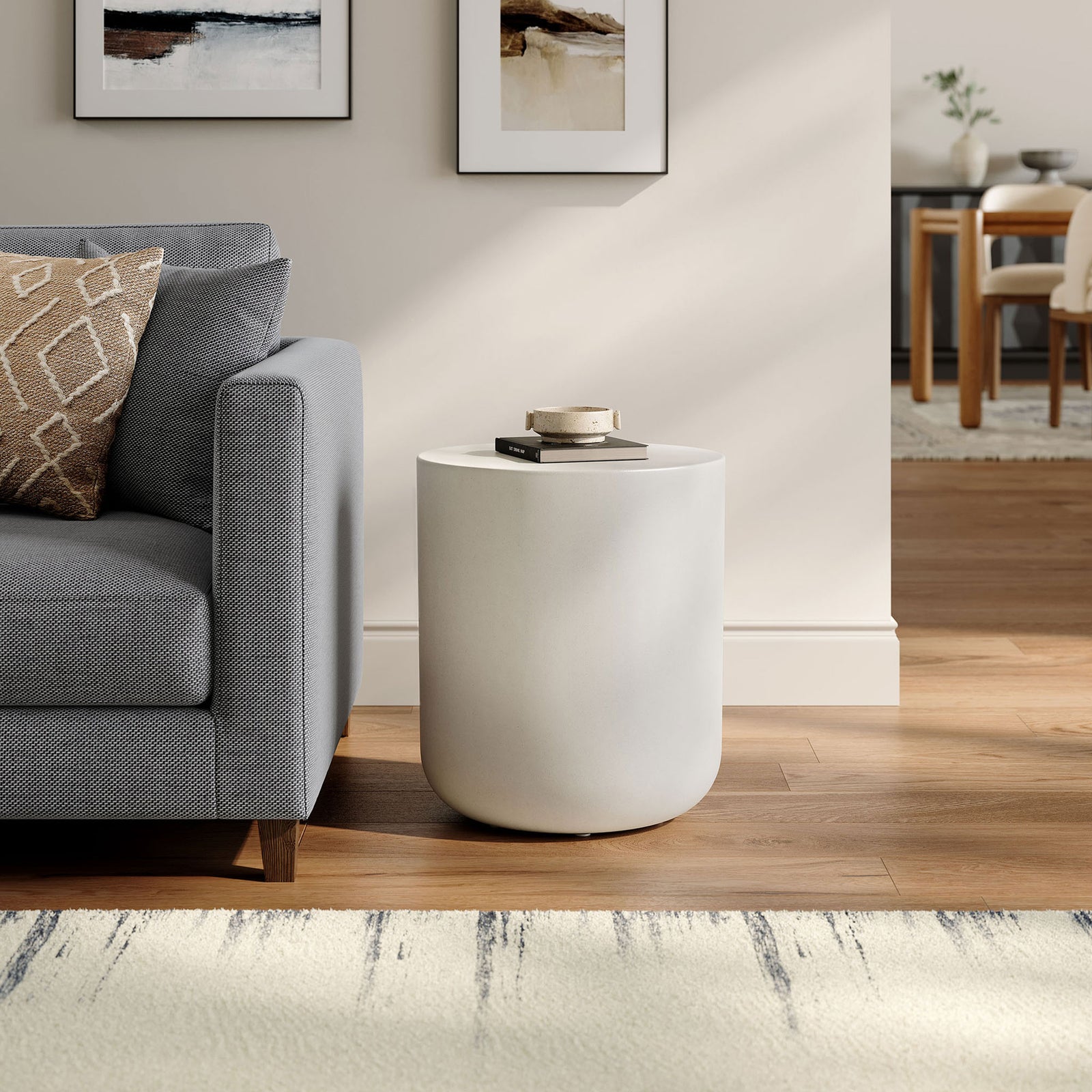 Brion white concrete stool beside a sofa, creating a crisp modern accent and functional side table || EEI-7088-WHI || front_angle_room