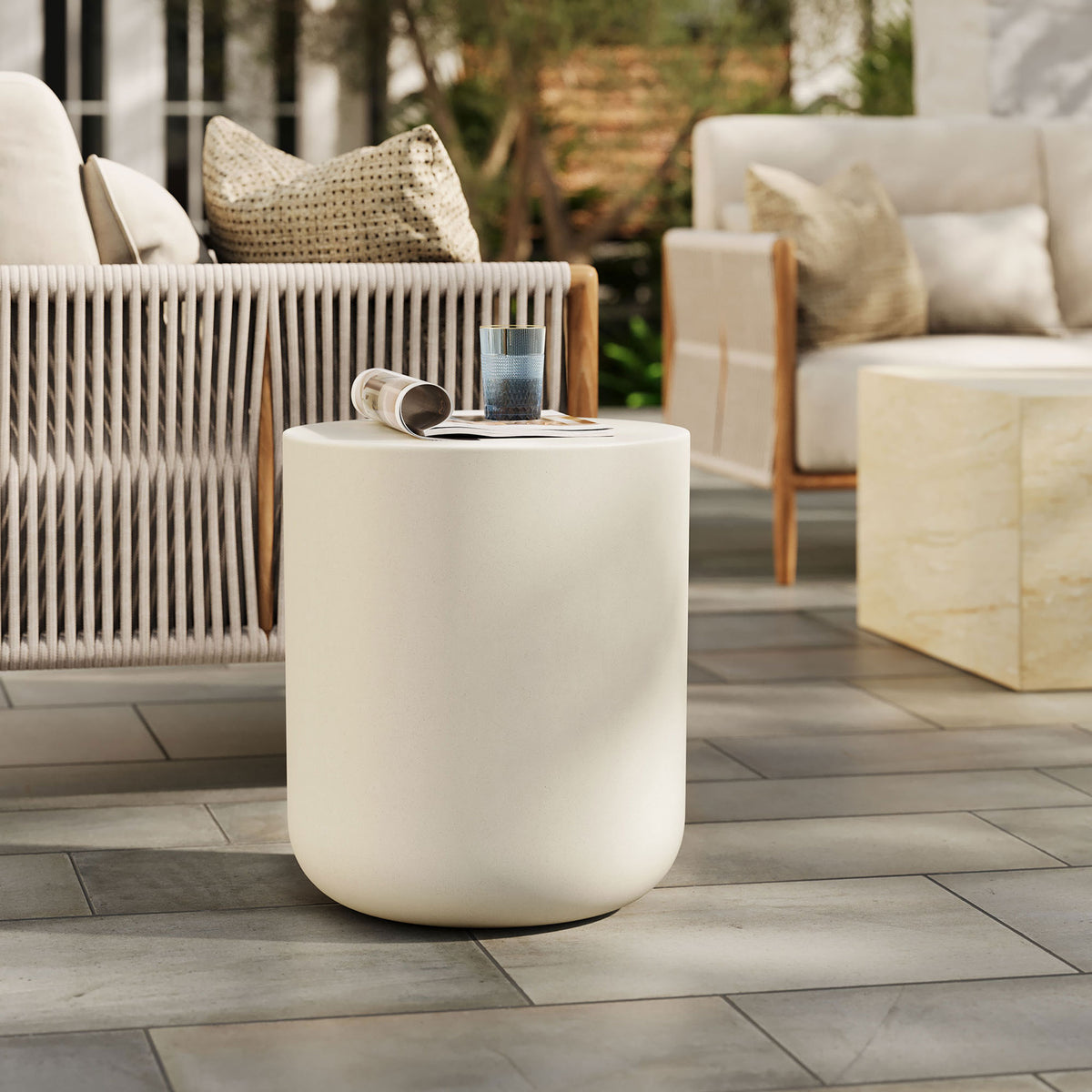 Brion white concrete stool completing an outdoor seating area as a versatile accent table or seat || EEI-7088-WHI || front_angle_room