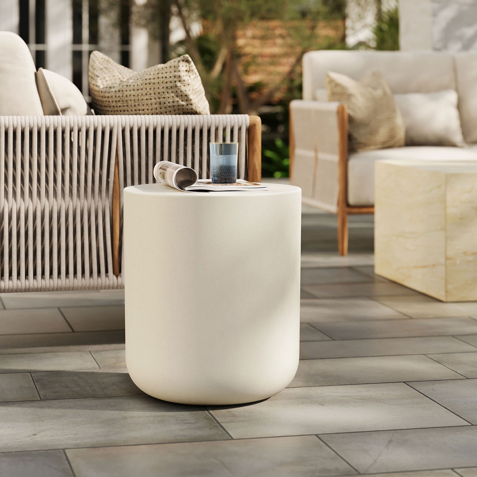 Brion white concrete stool completing an outdoor seating area as a versatile accent table or seat || EEI-7088-WHI || front_angle_room