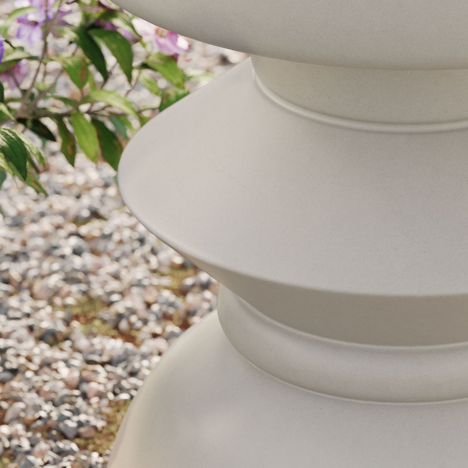 Light gray concrete side table base adding sculptural form to an outdoor garden setting || EEI-7090-LGR || detail_room