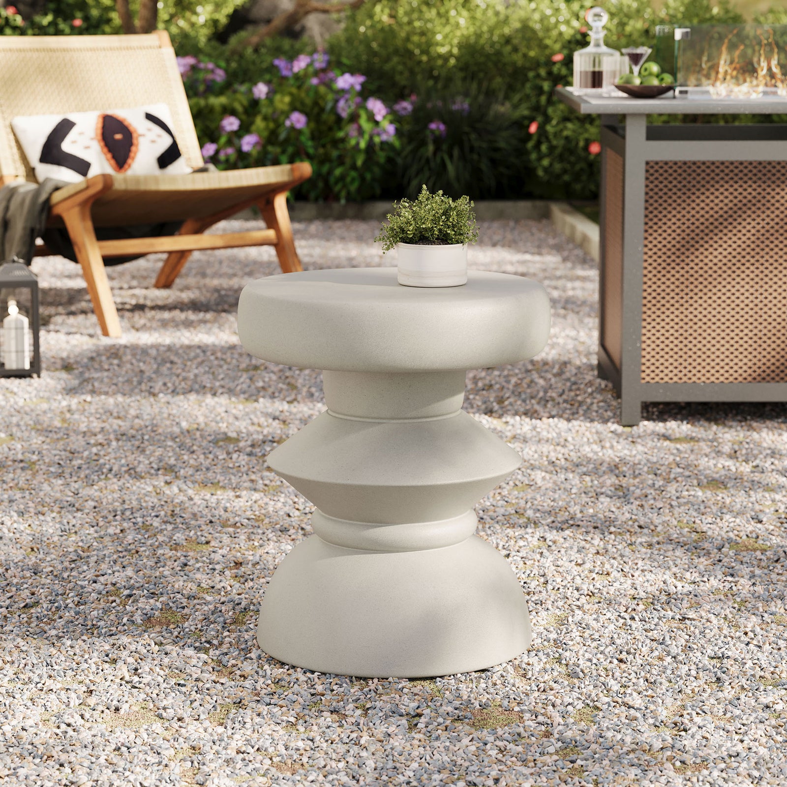 Light gray concrete side table used as an outdoor accent table on a modern gravel patio || EEI-7090-LGR || front_angle_room