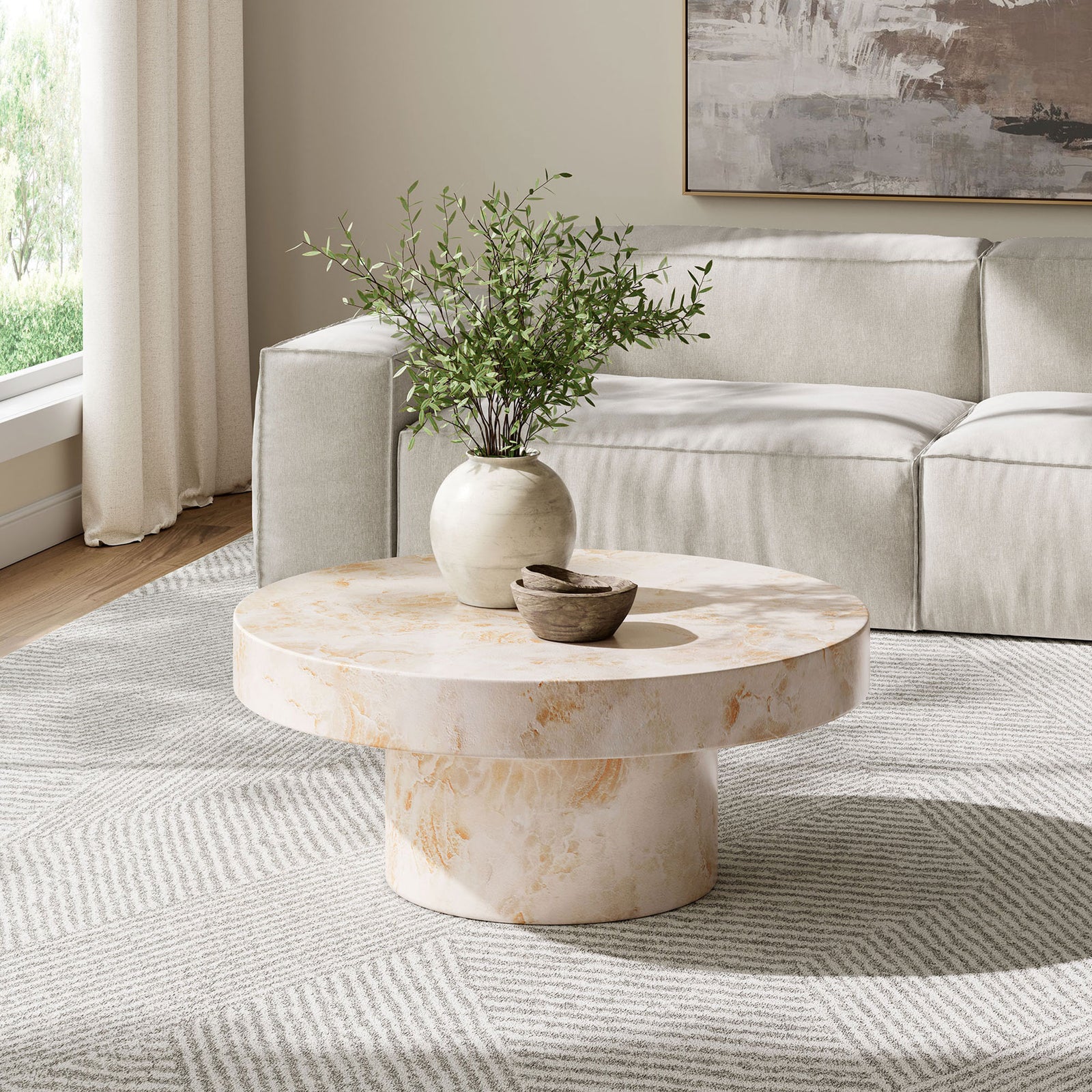Honey onyx round coffee table centered in a modern neutral living room with plush sofa || EEI-7091-HYX || front_angle_room