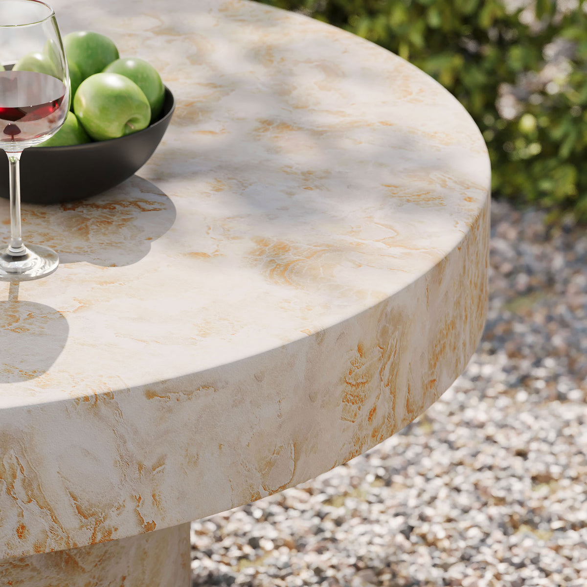 Honey onyx coffee table used outdoors with fruit bowl and wine glass on a gravel patio || EEI-7091-HYX || detail_room