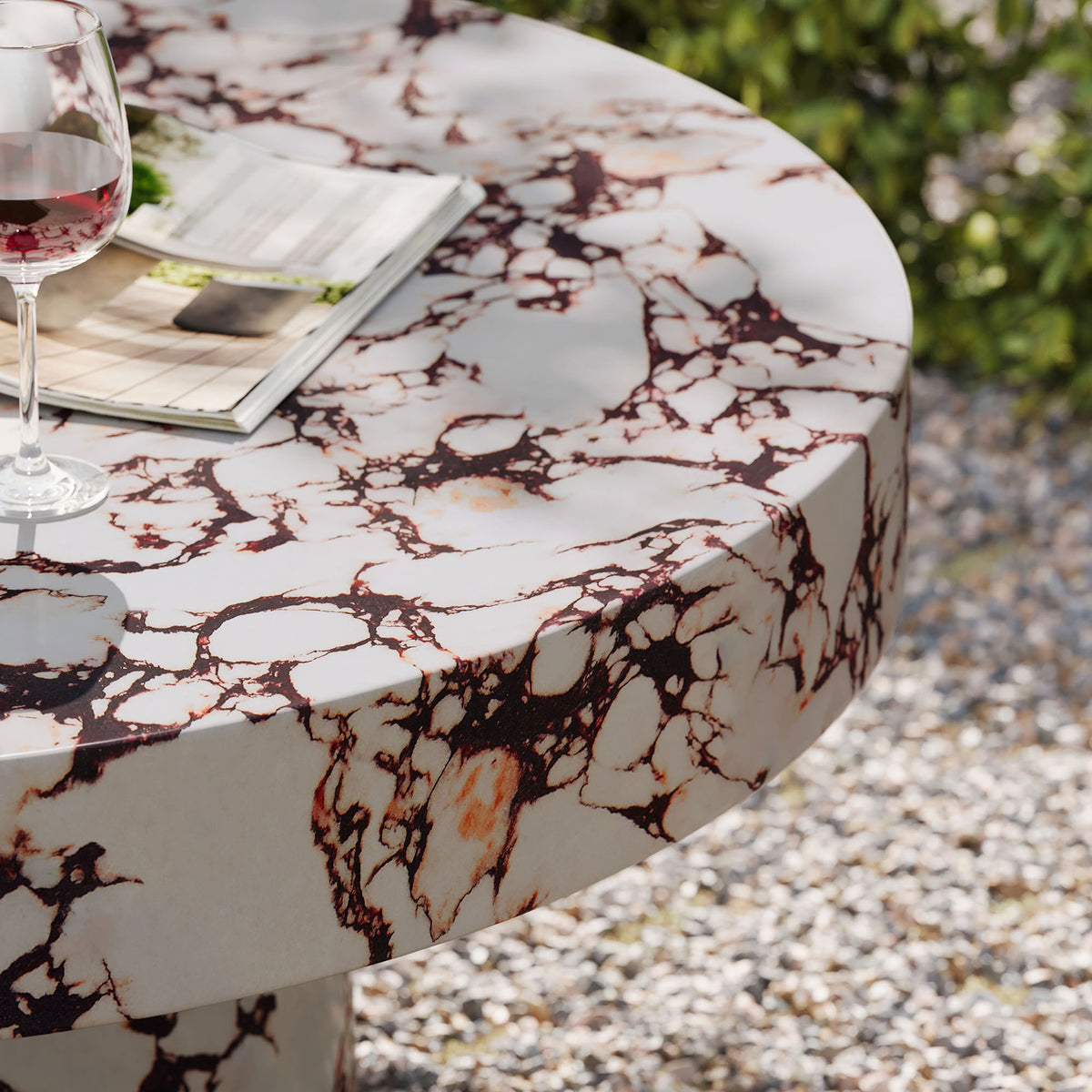 Red marble look coffee table used outdoors with wine glass and reading material on patio || EEI-7091-RED || detail_room