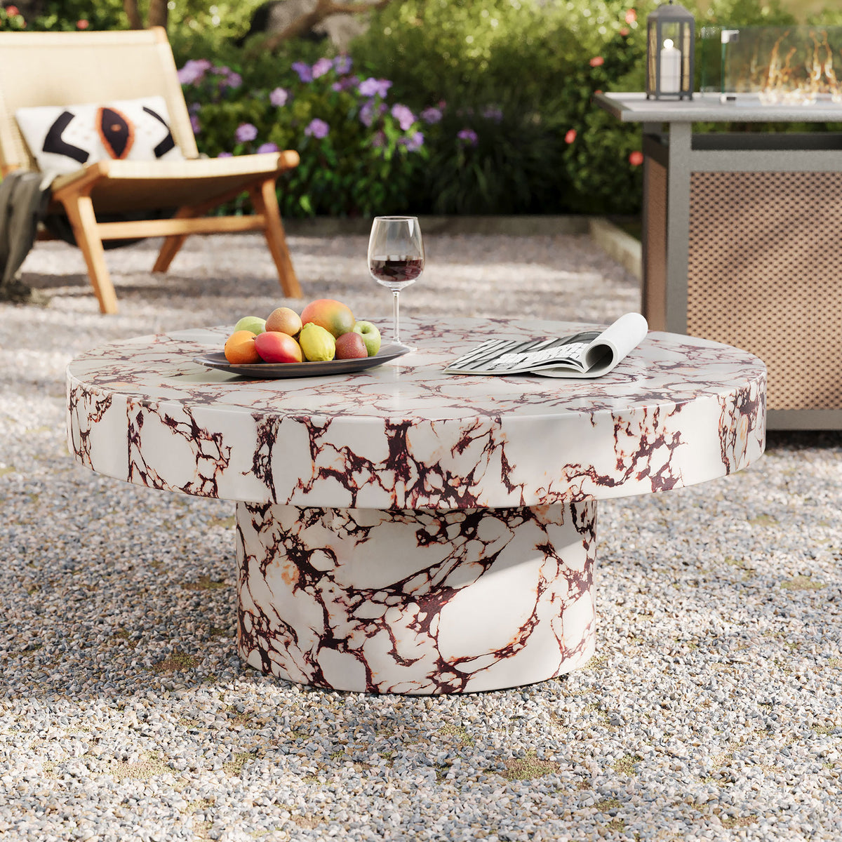 Red marble effect round coffee table creating a focal point in a lush outdoor lounge || EEI-7091-RED || front_angle_room