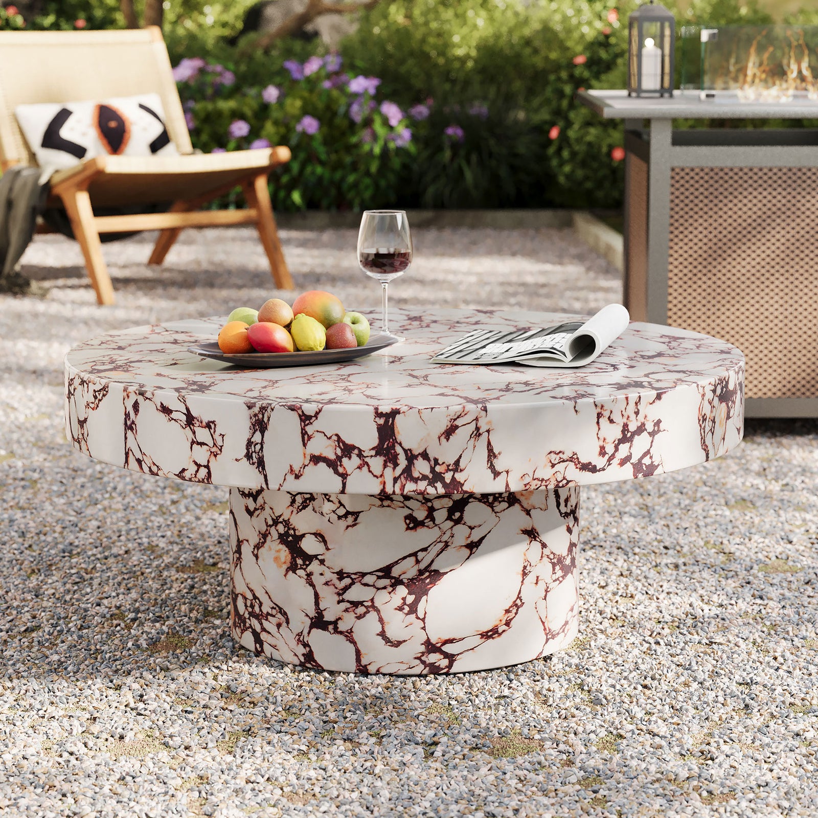 Red marble effect round coffee table creating a focal point in a lush outdoor lounge || EEI-7091-RED || front_angle_room