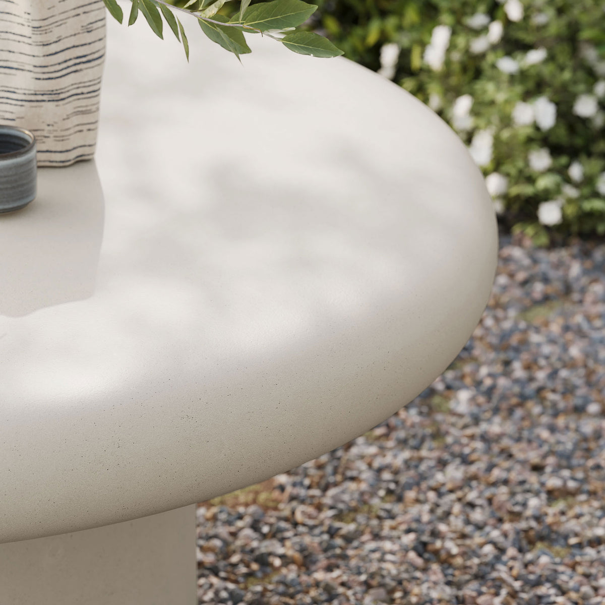 White concrete tabletop with subtle speckling bringing a fresh stone look to relaxed outdoor lounging spaces || EEI-7092-WHI || detail_room