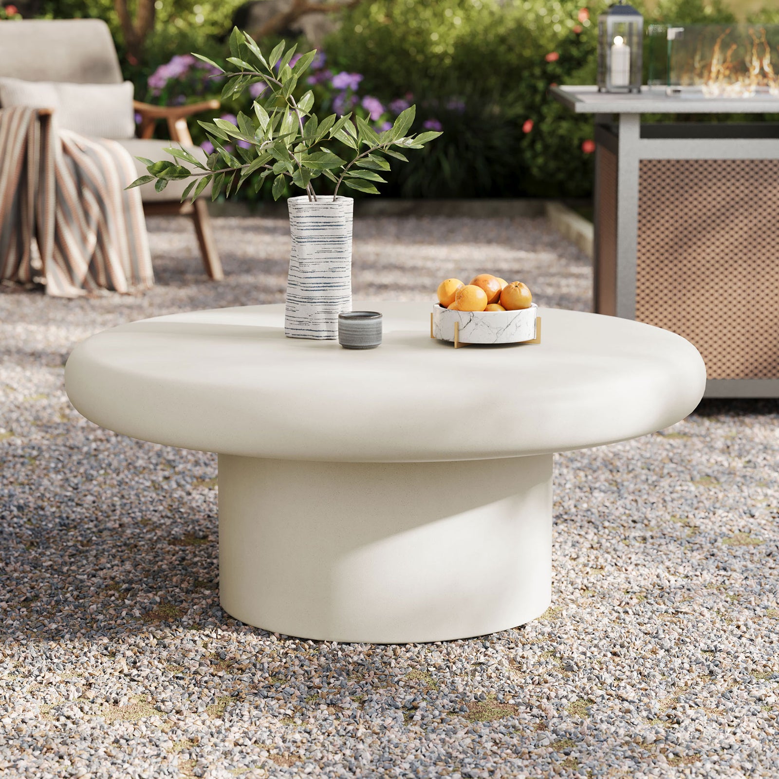 Low white concrete round coffee table with cylindrical base creating a modern focal point for patio gatherings || EEI-7092-WHI || front_angle_room