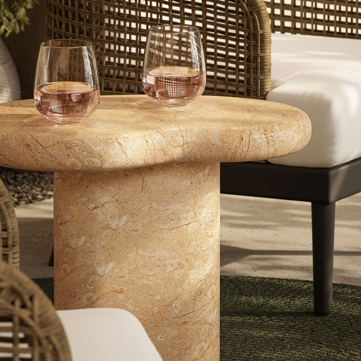 Faux travertine tabletop styled outdoors with glasses of rose wine, adding a refined stone look to the patio || EEI-7094-TRV || detail_room