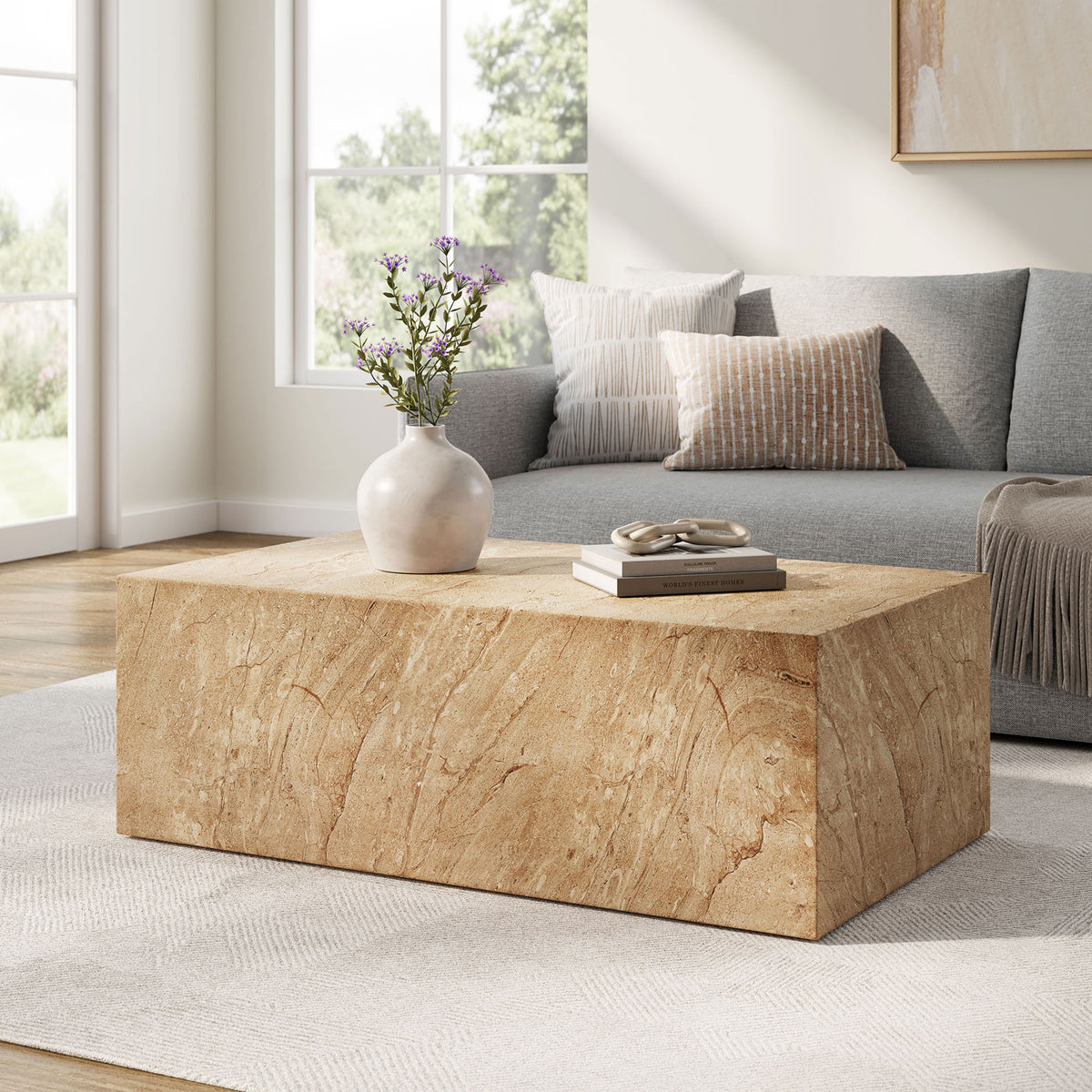 Jordana travertine-look concrete coffee table grounds a sunlit living room with its bold plinth silhouette || EEI-7095-TRV || front_angle_room