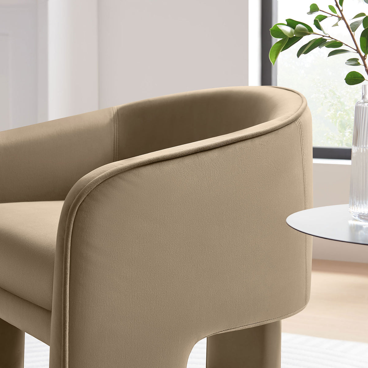Soft velvet upholstery and smooth piping accentuate the chair's rounded arms and clean, contemporary profile || EEI-7102-TAU || detail_room