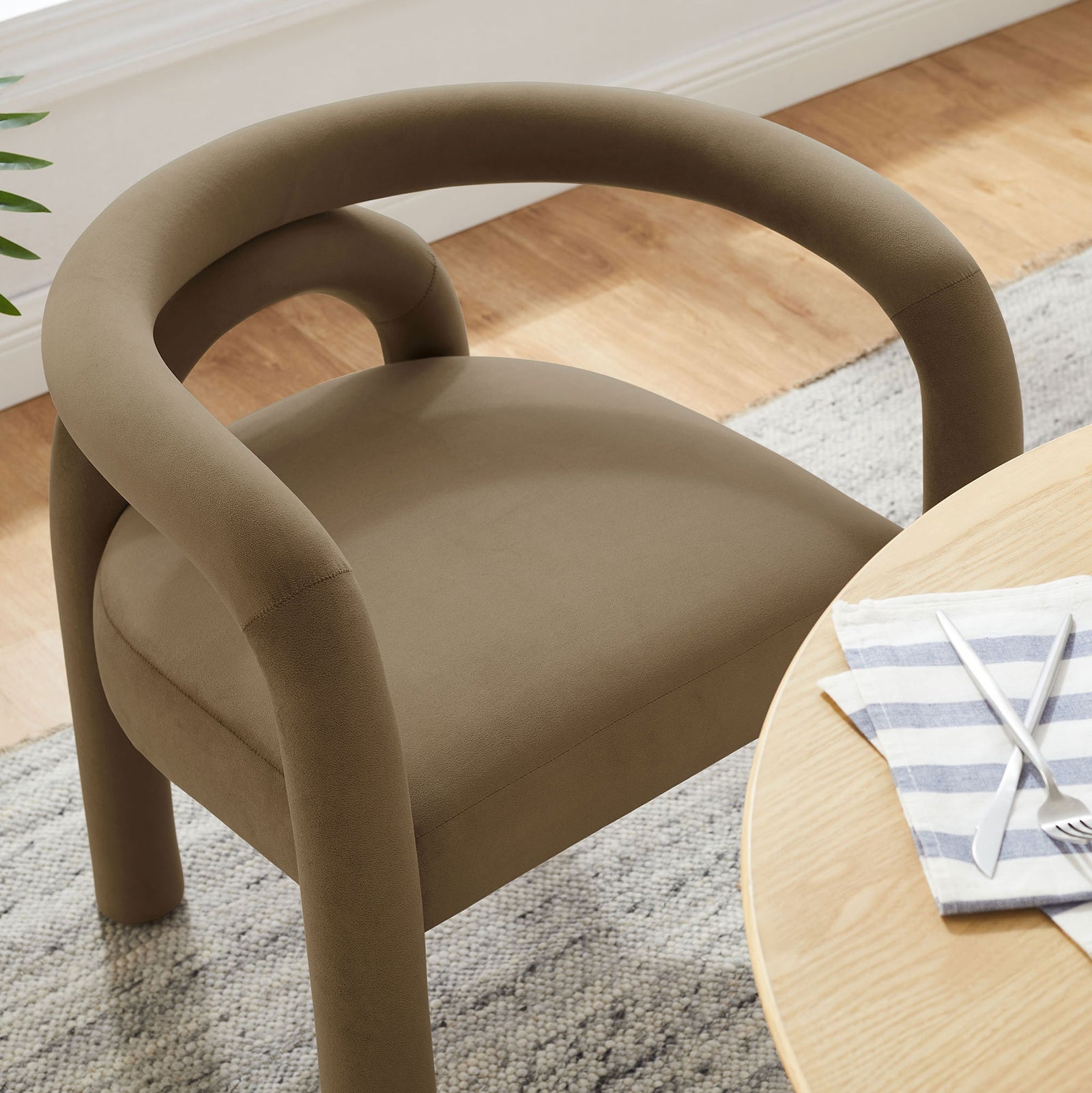 Camel velvet barrel chair at a dining table, showcasing its comfortable seat in a bright modern room || EEI-7104-CAM || detail_room