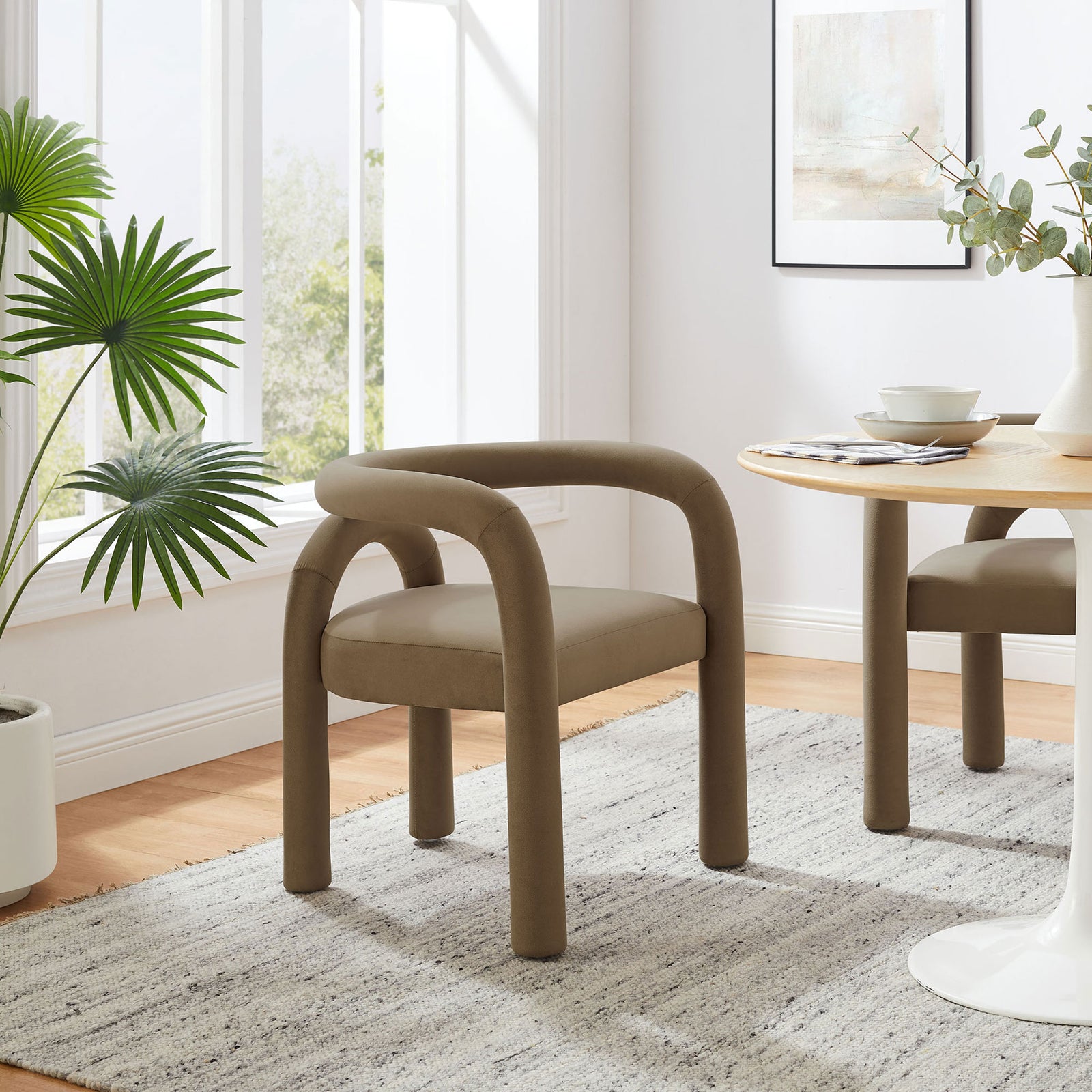 Styled dining nook featuring the camel Astrid barrel chair paired with a light wood table and rug || EEI-7104-CAM || front_angle_room
