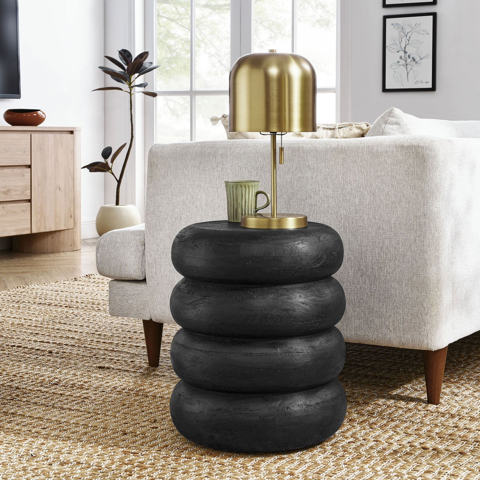 Black stacked wood side table beside sofa styled with lamp and mug in modern living room || EEI-7106-BLK || front_room