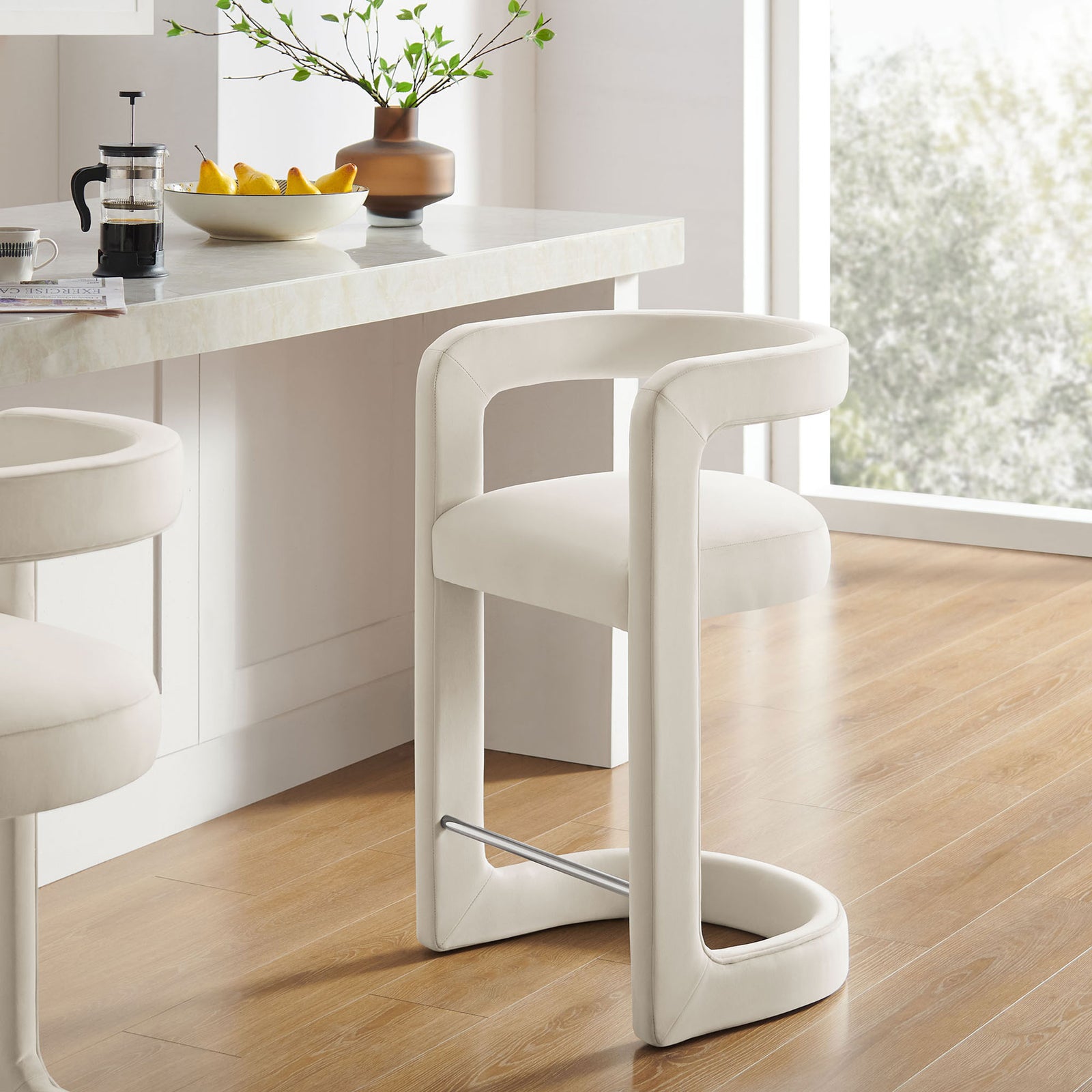 Counter-height stool with arched base and polished footrest, styled for modern kitchens || EEI-7107-ALA || front_angle_room
