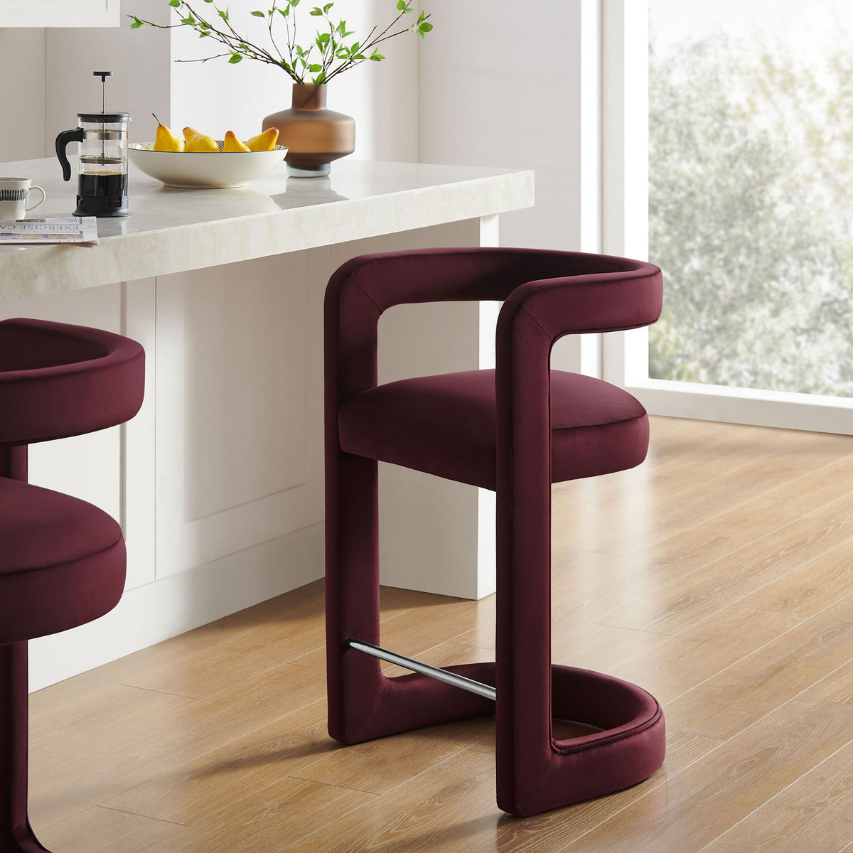 Elevate your kitchen with a plush velvet counter stool in a rich mulberry hue and polished footrest. || EEI-7107-MUL || front_angle_room