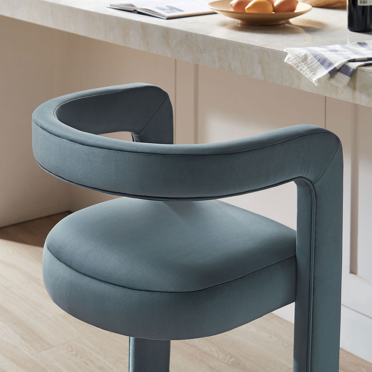 Rounded back and cushioned seat in cadet blue velvet elevate everyday bar seating || EEI-7108-CAB || detail_room