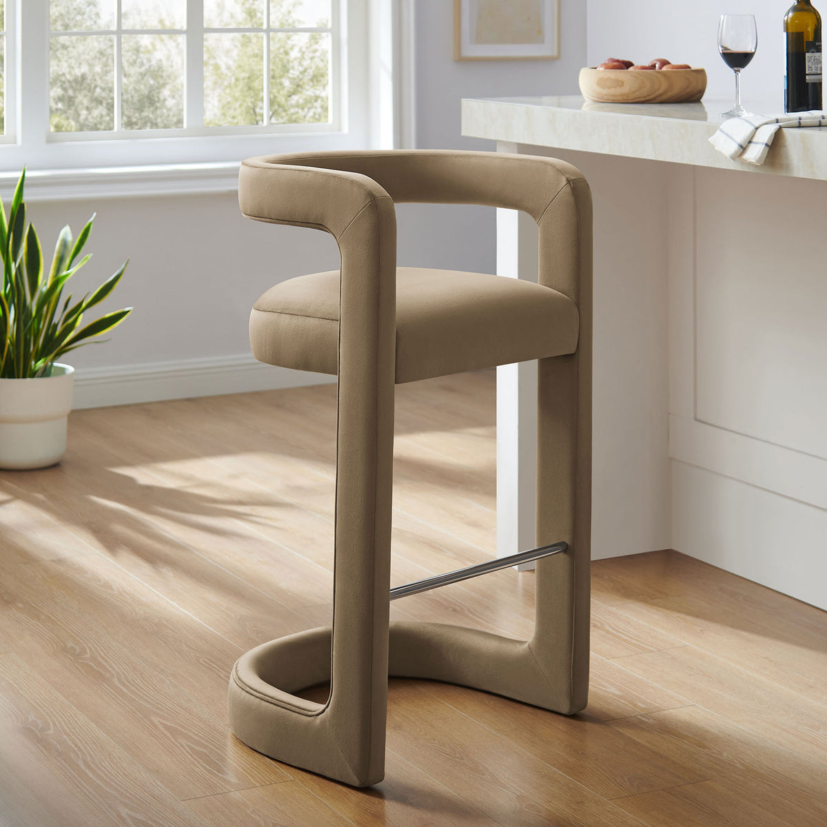 Stylish taupe velvet bar stool refreshes the kitchen with modern curves and a steel footrest || EEI-7108-TAU || front_angle_room