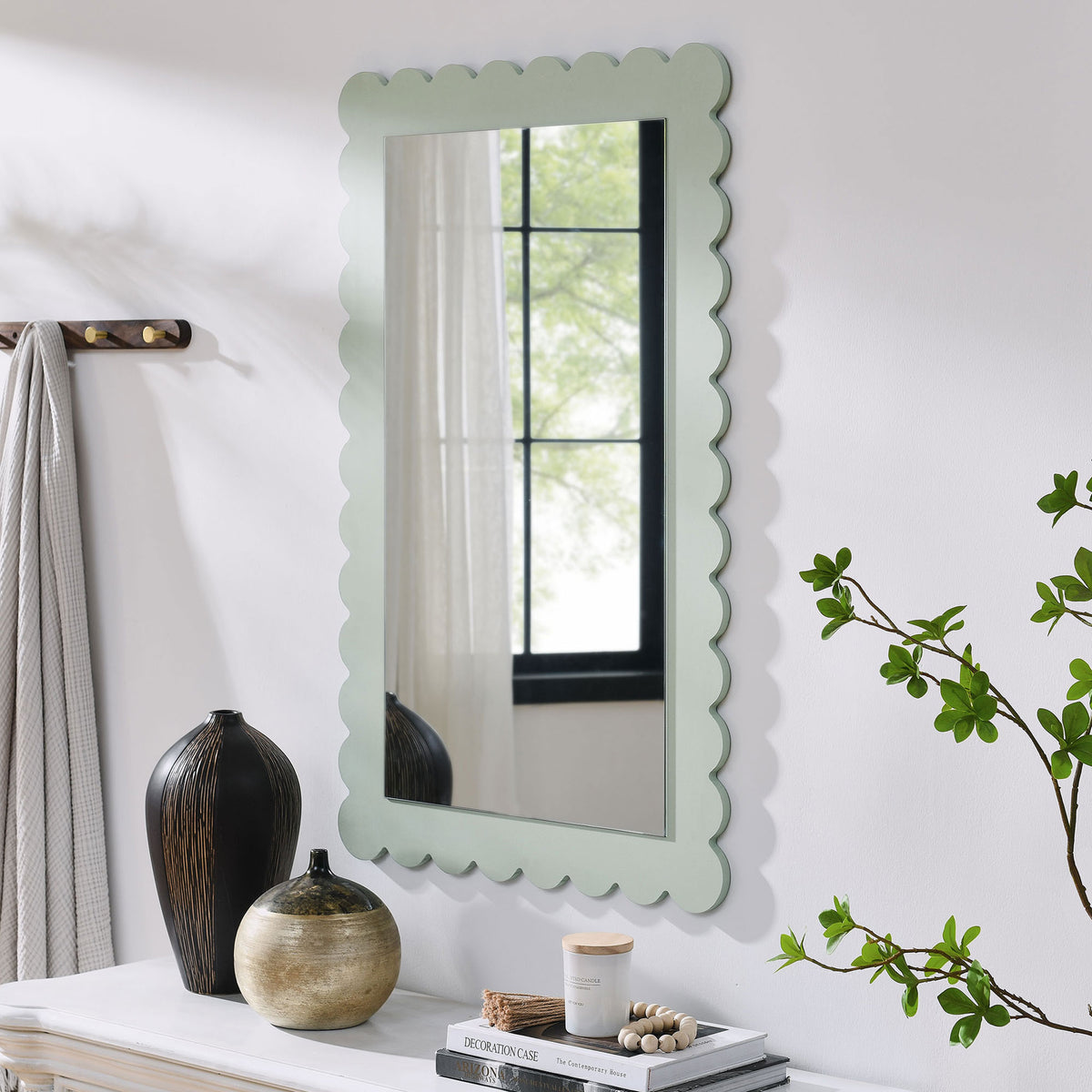 Sage green scalloped mirror styled above a console table for everyday entryway charm || EEI-7116-SGE || front_angle_room