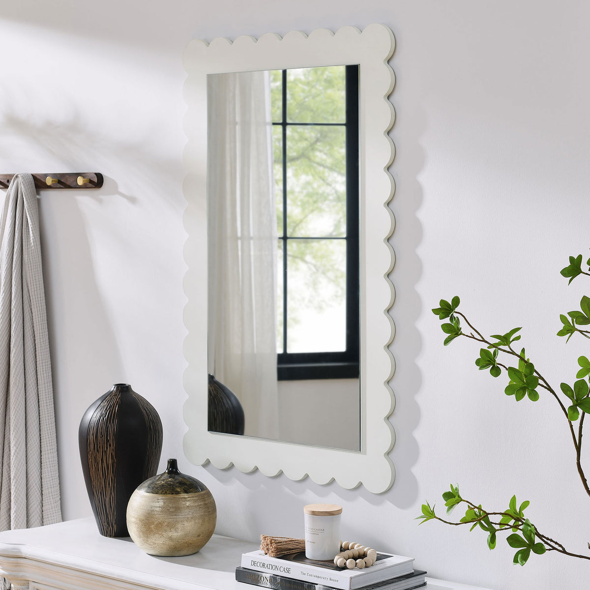 White scalloped mirror styled above a console table for everyday entryway charm || EEI-7116-WHI || front_angle_room