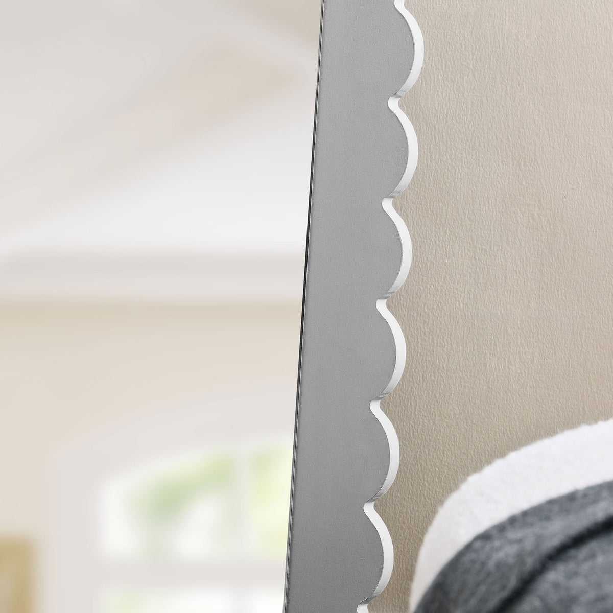 Scalloped gray mirror edge adds soft curves and texture against a bright, airy bedroom wall || EEI-7117-LGR || detail_room