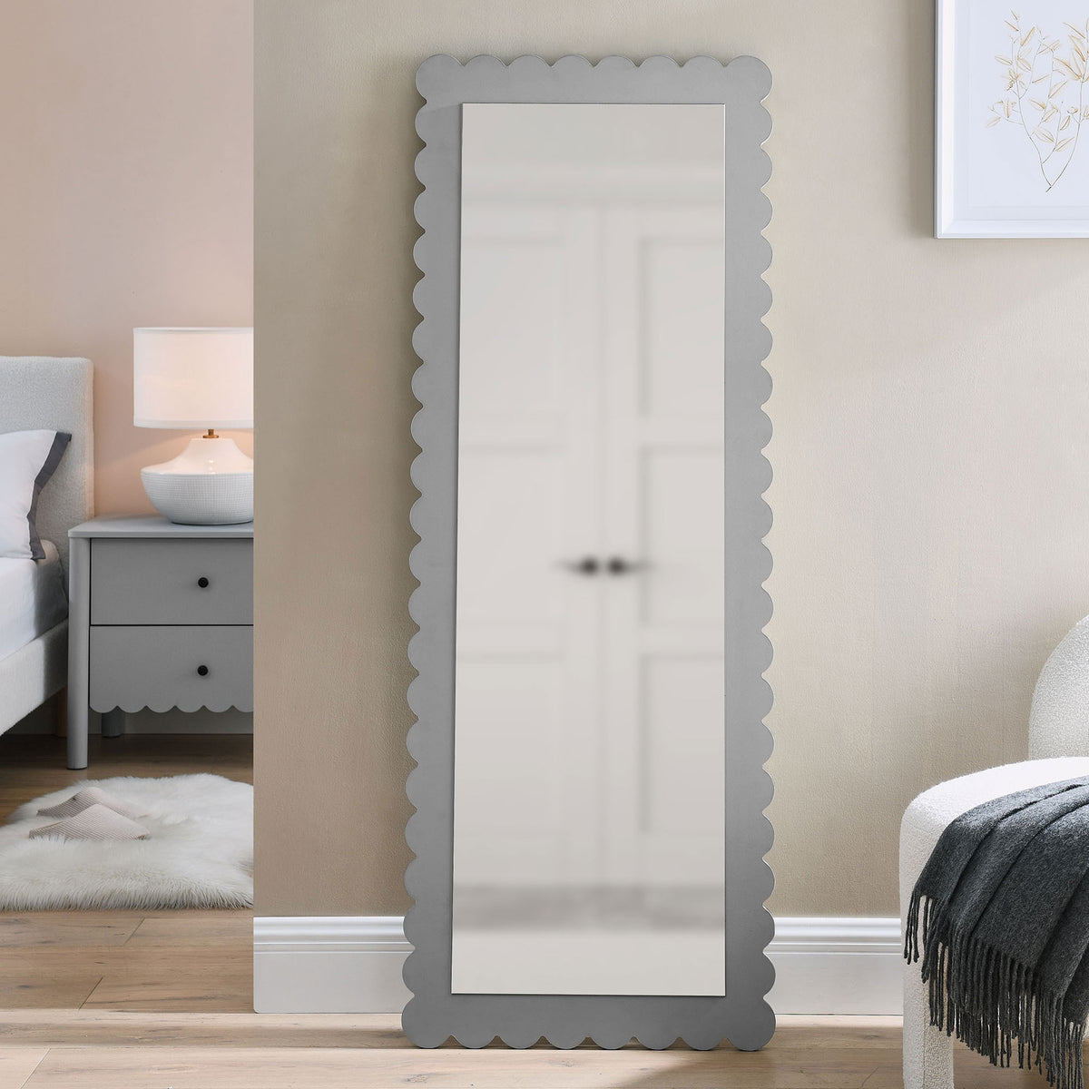 Light gray scalloped floor mirror leans gracefully in a cozy bedroom for full-length reflection || EEI-7117-LGR || front_room