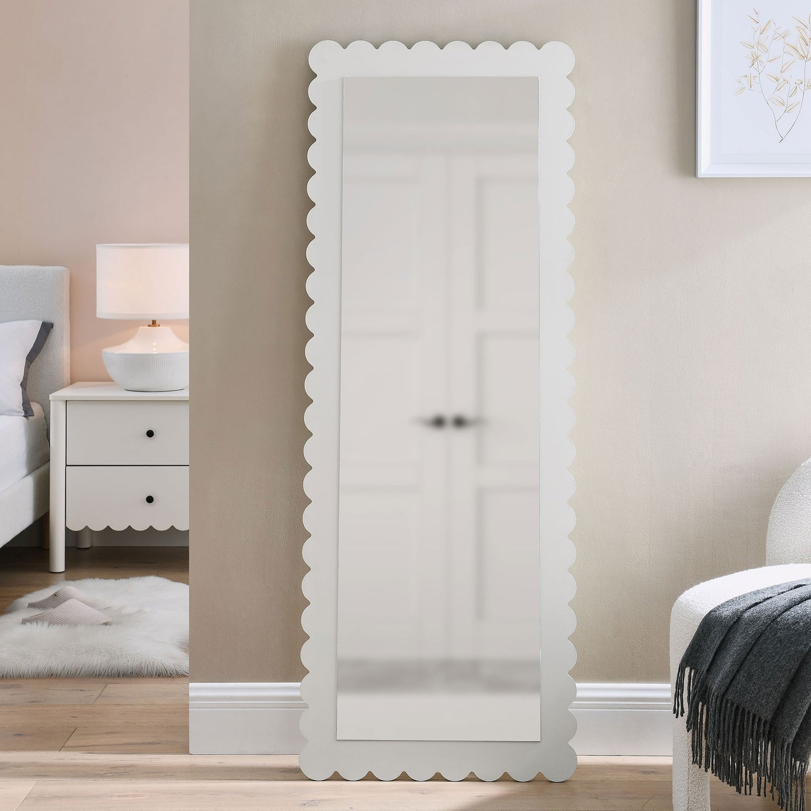 Full-length scalloped floor mirror styled beside a bed in a cozy neutral bedroom || EEI-7117-WHI || front_room