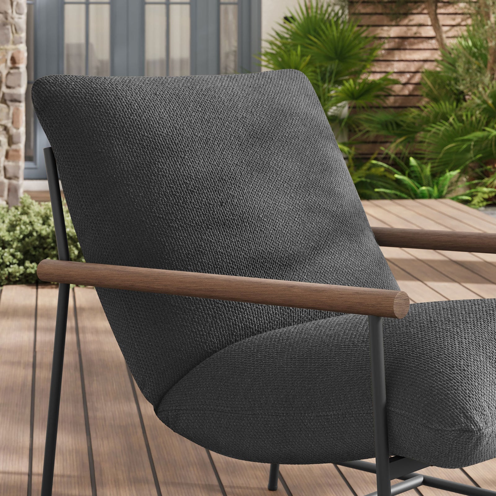 Charcoal boucle lounge chair arm and cushion bringing soft texture to an outdoor deck setting || EEI-7118-CHA || detail_room
