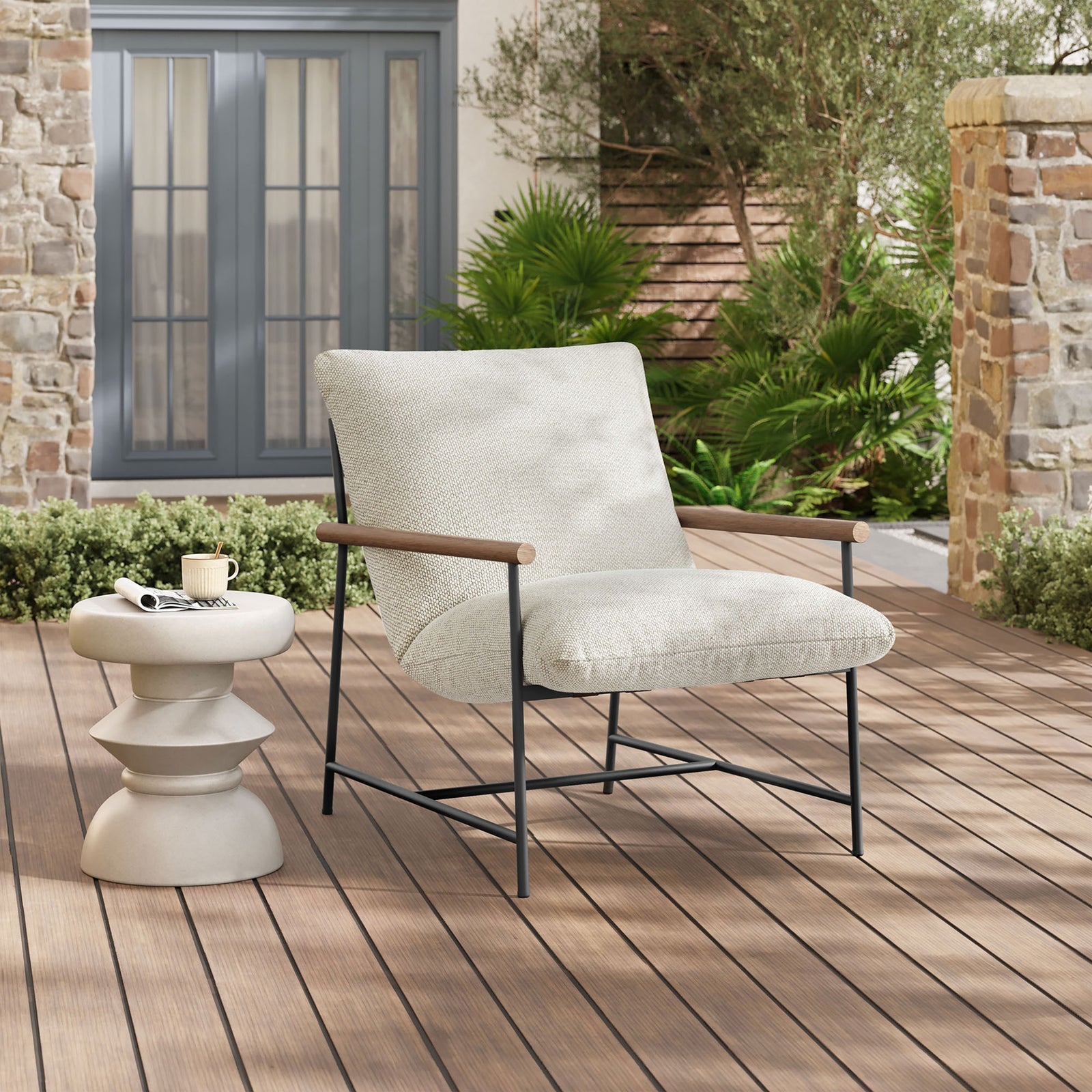 Ivory boucle sling lounge chair styled on a contemporary deck beside a round concrete side table || EEI-7118-IVO || front_angle_room