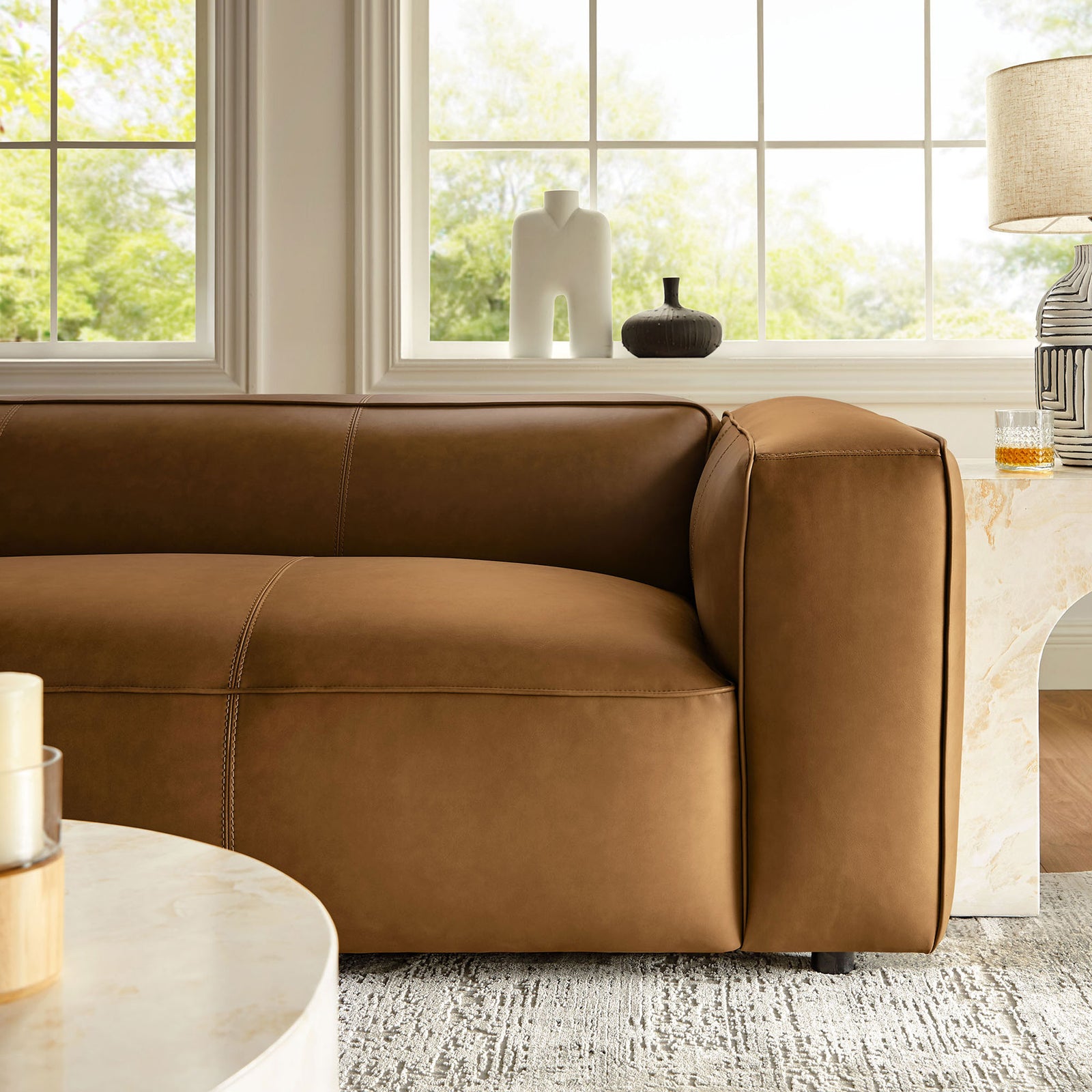 Camel vegan leather sofa arm styled with marble side table and cozy living room decor || EEI-7119-CAM || detail_room