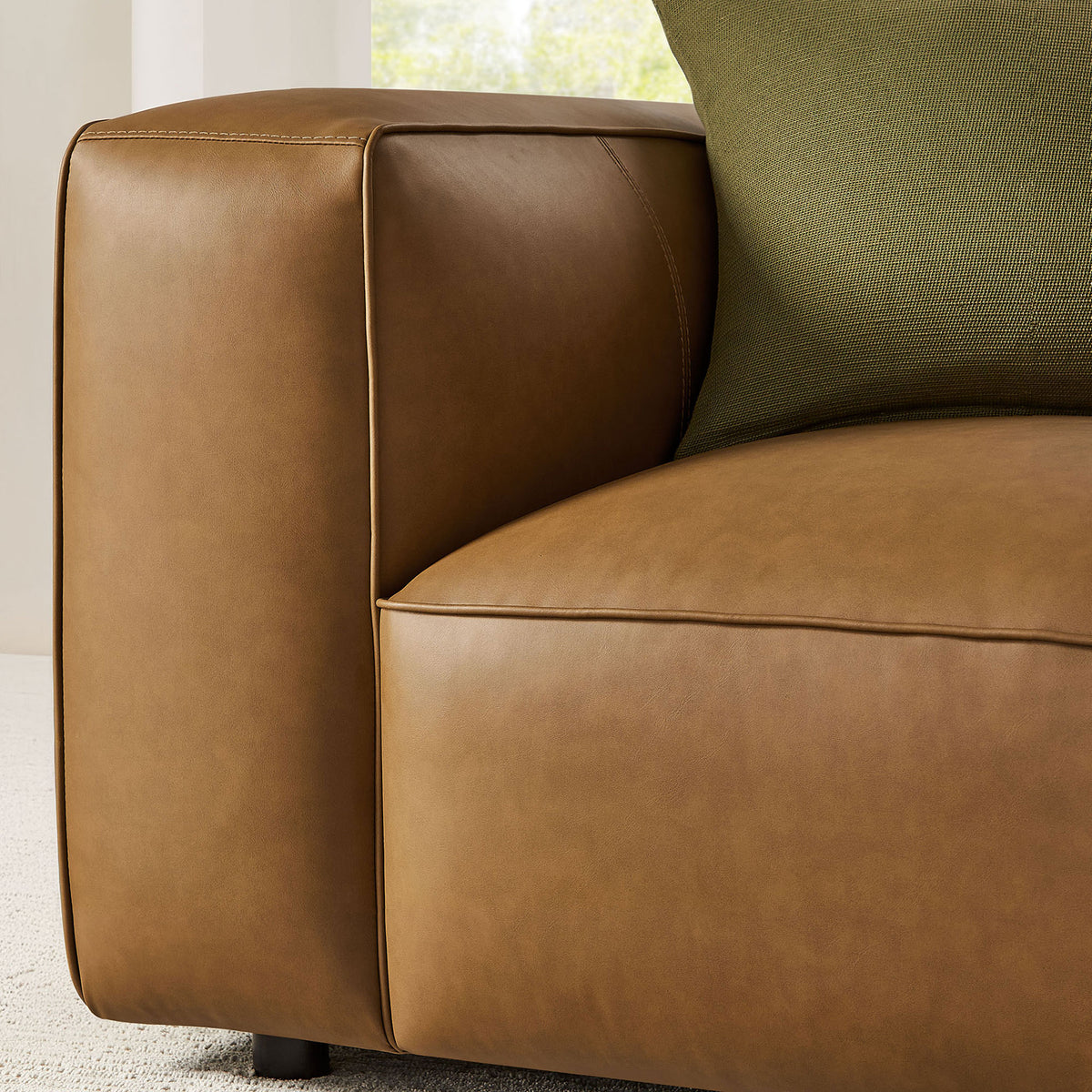 Padded arm and seat showcasing supple vegan leather and fine seamwork || EEI-7120-CAM || detail_room