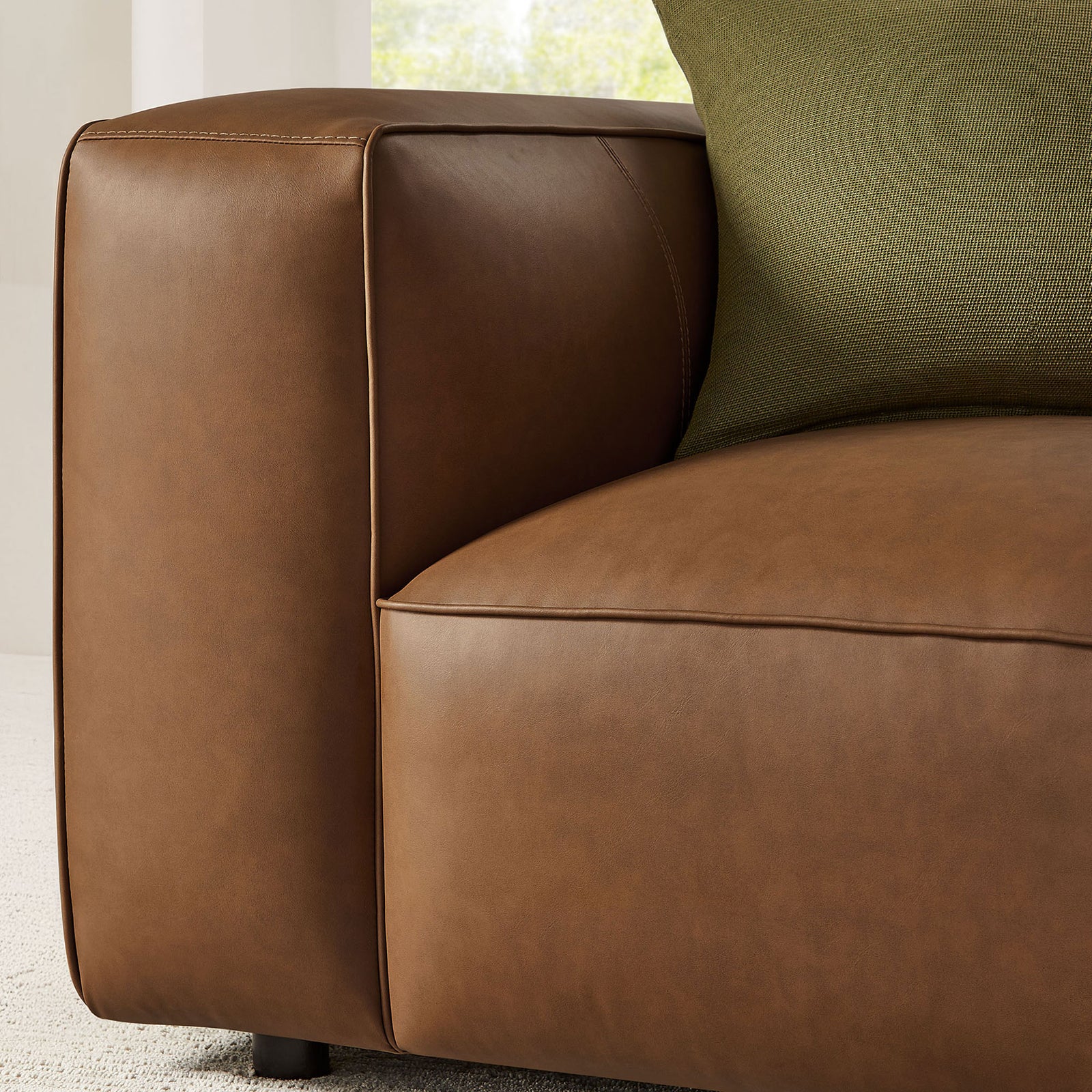 Softly padded arm and seat showcase refined stitching and smooth vegan leather finish || EEI-7120-COF || detail_room