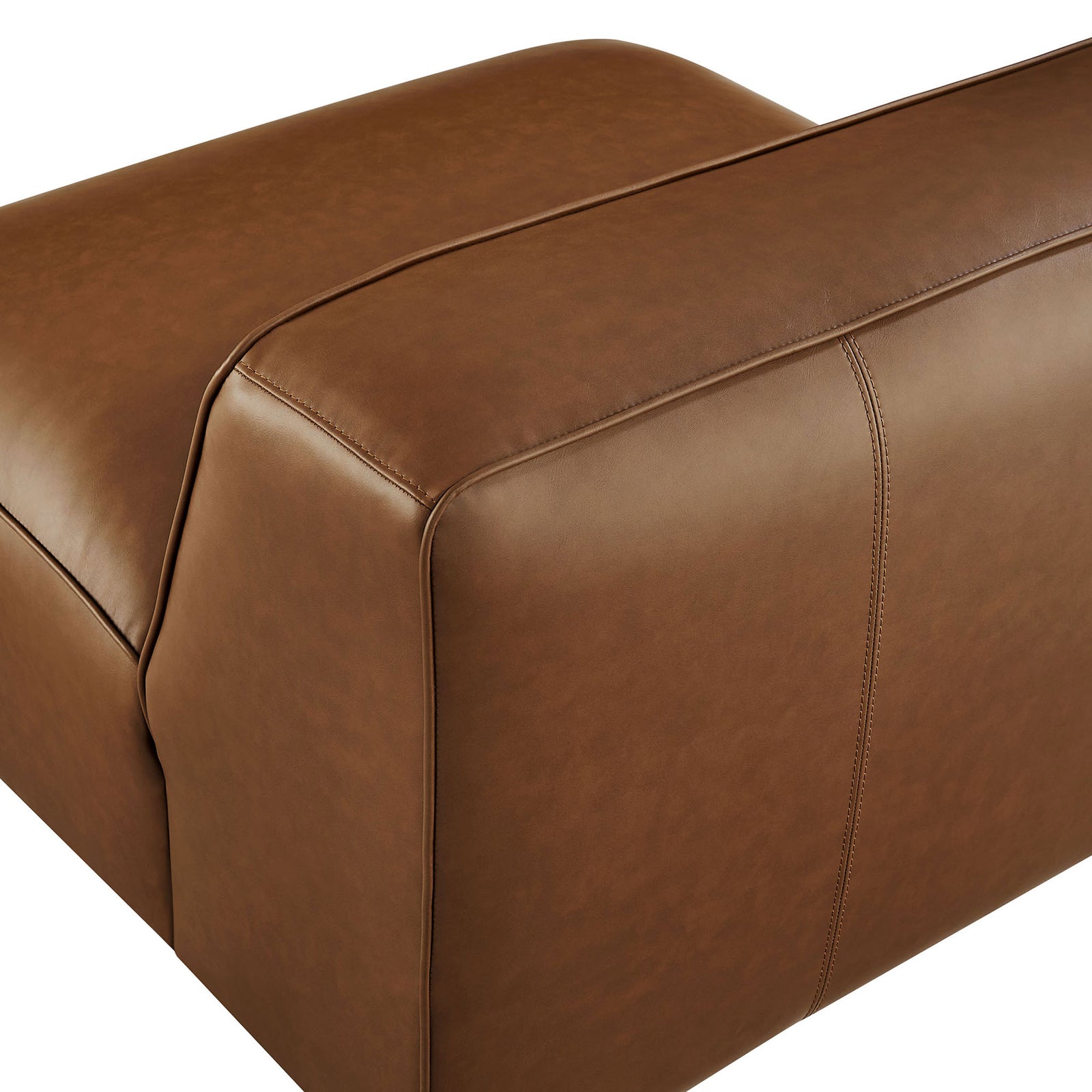 Finely stitched trim and soft, rounded edges emphasize the chair's sleek, sculpted form || EEI-7121-COF || detail_studio