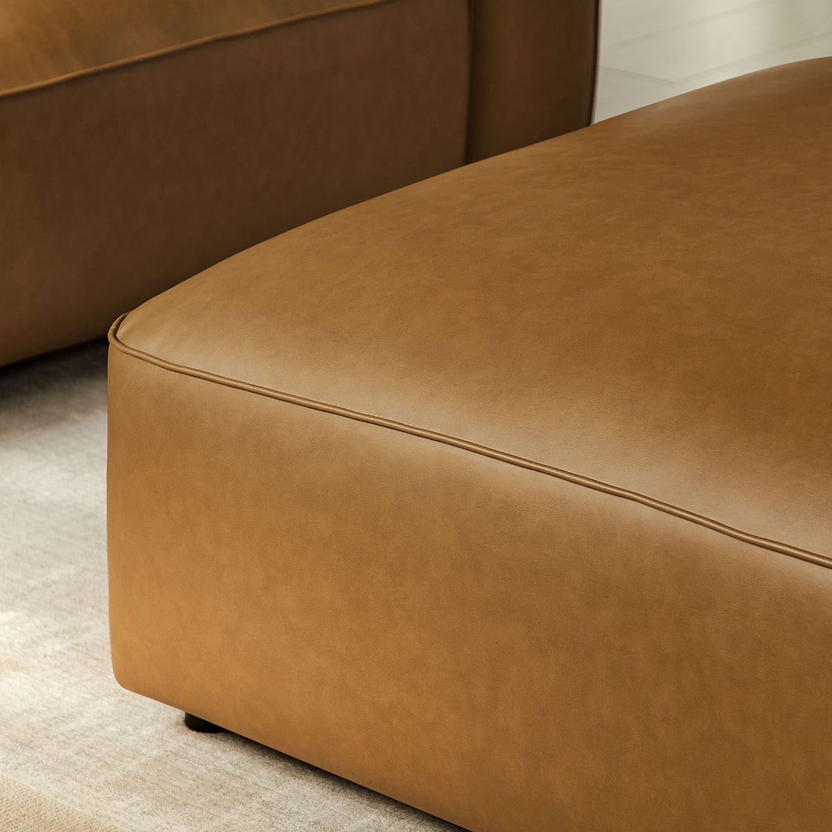 Detail of camel vegan leather ottoman cushion with dense foam padding and subtle sheen || EEI-7125-CAM || detail_room