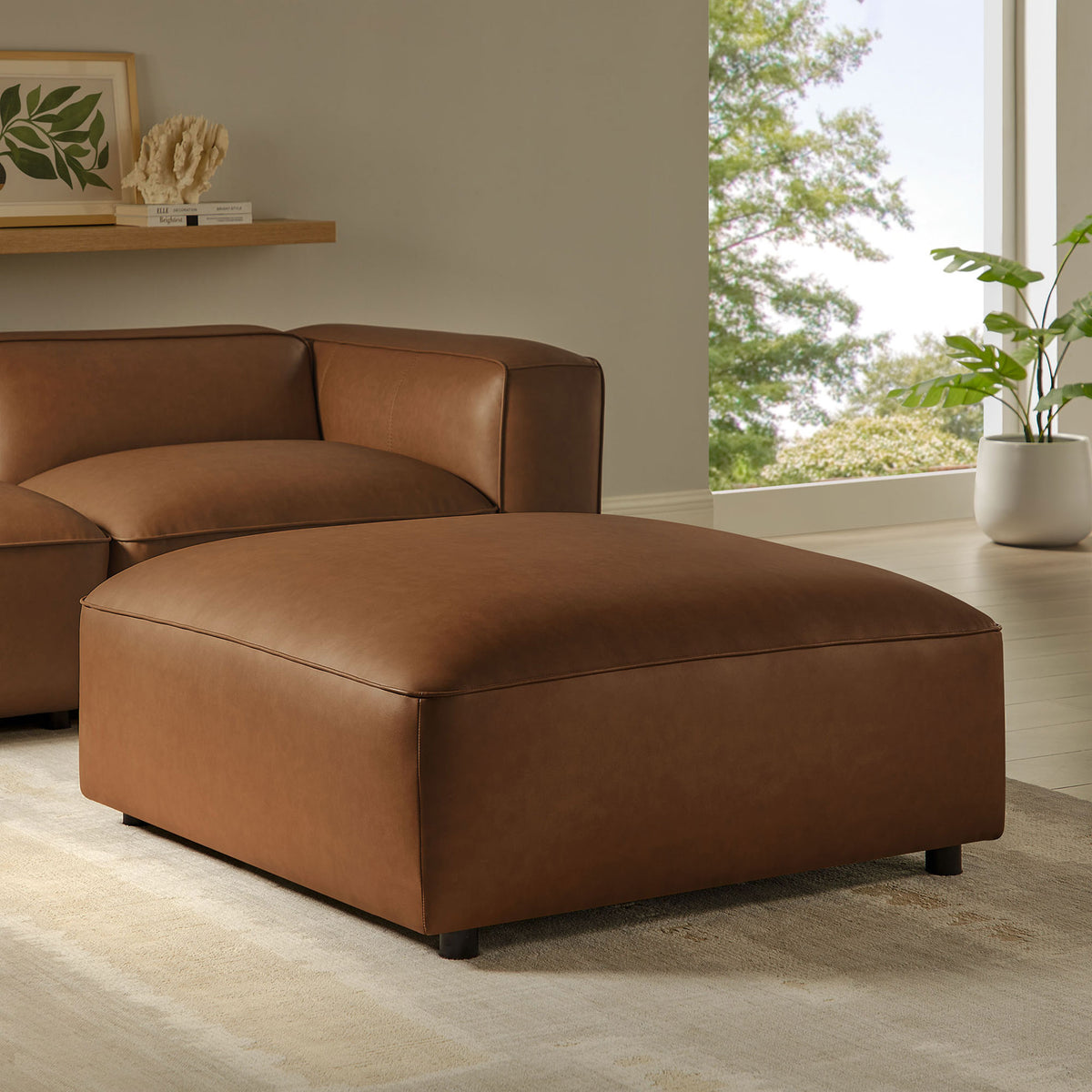 Coffee vegan leather ottoman styled with matching seating, creating a cozy, modern living room centerpiece || EEI-7125-COF || front_angle_room
