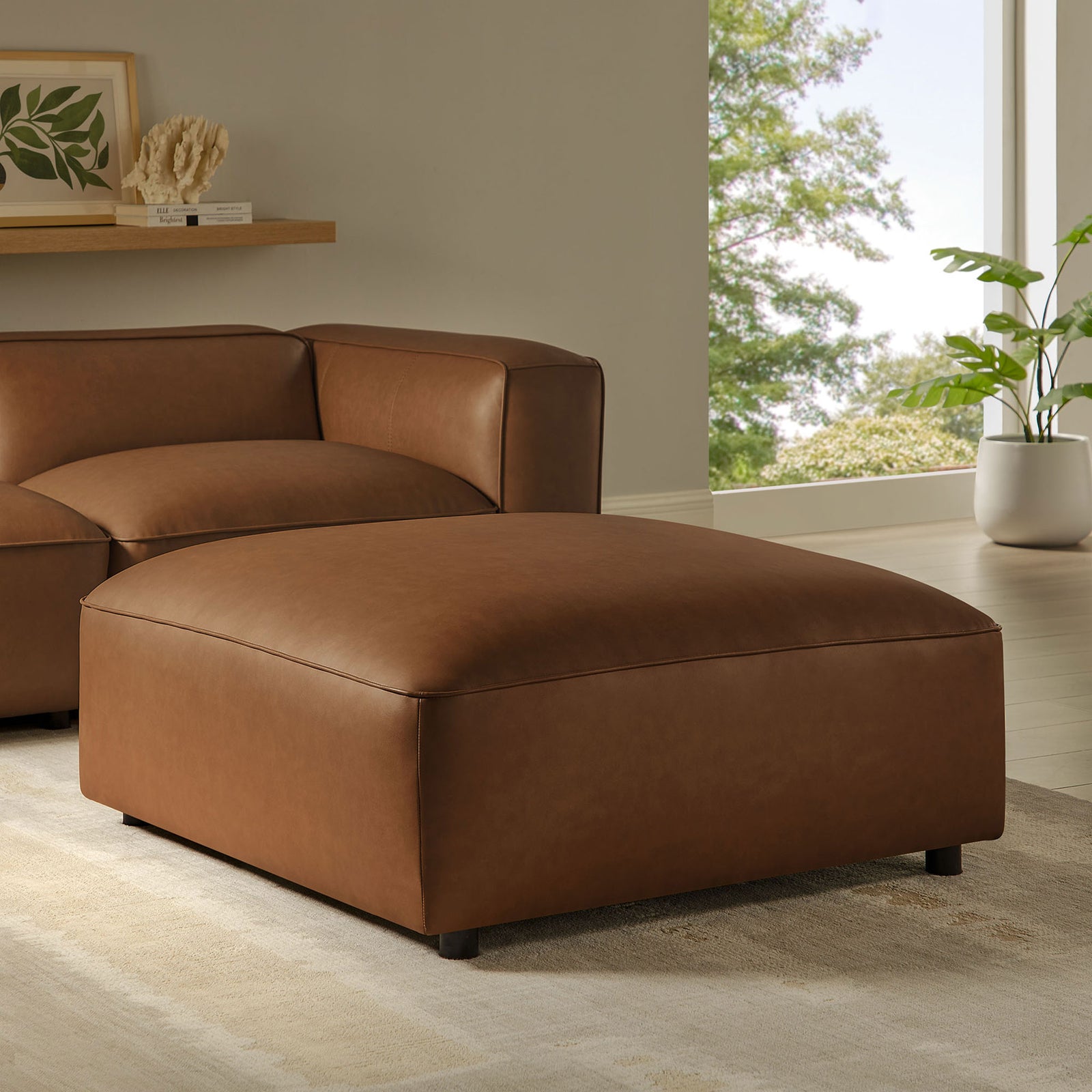 Coffee vegan leather ottoman styled with matching seating, creating a cozy, modern living room centerpiece || EEI-7125-COF || front_angle_room