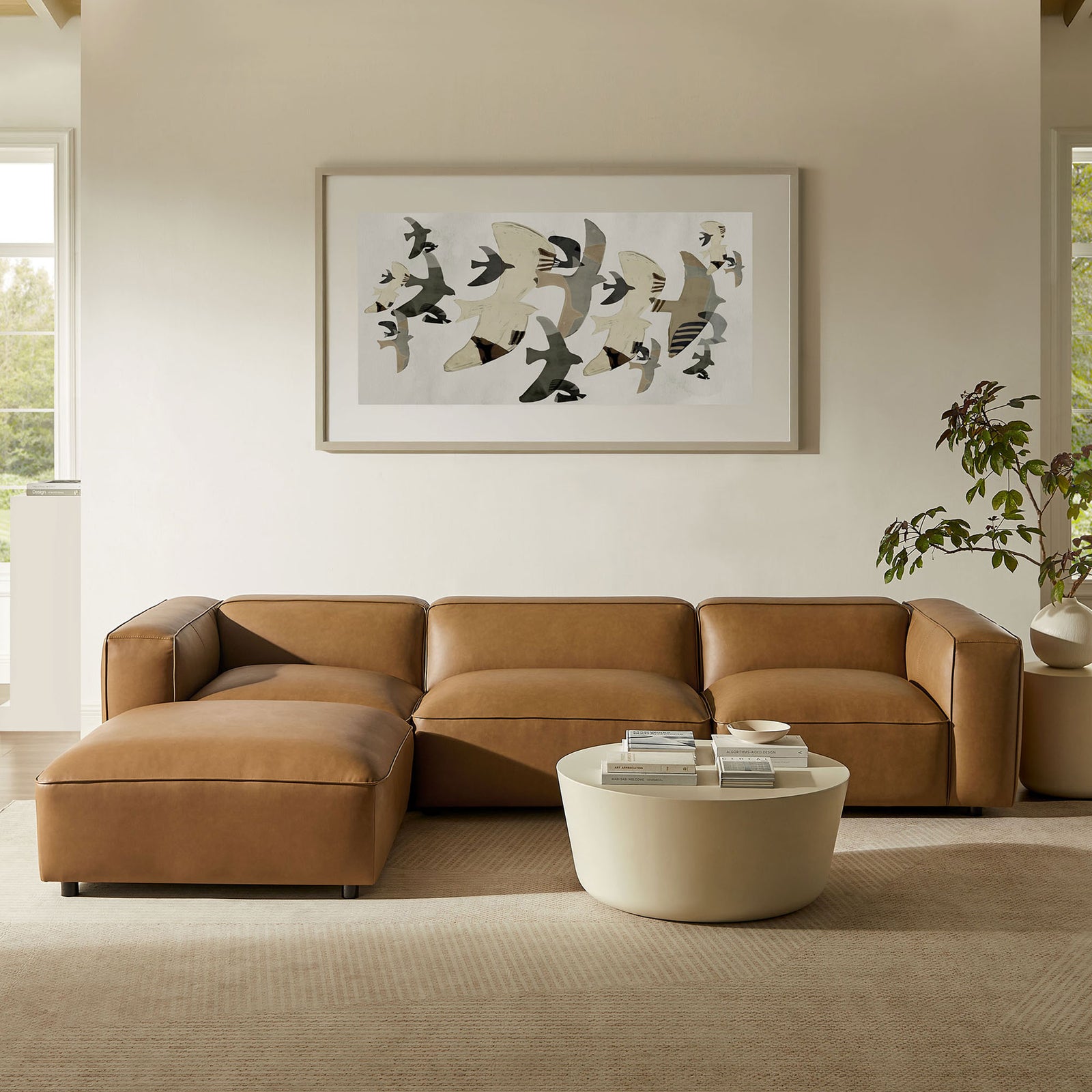 Camel vegan leather modular sectional with ottoman chaise styled in a bright, airy living room || EEI-7128-CAM || front_angle_room