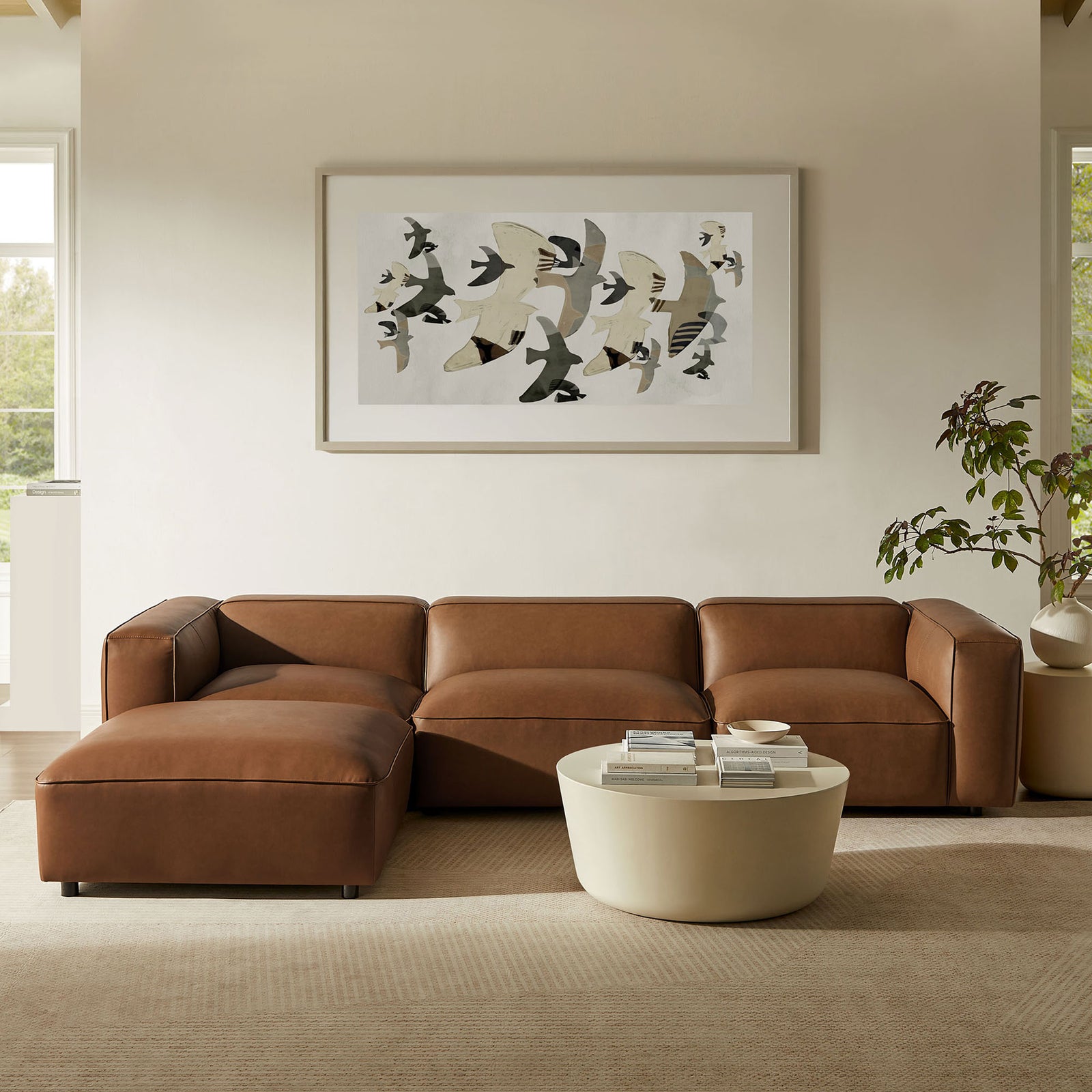 L shaped coffee vegan leather modular sectional with ottoman styled in a modern neutral living room || EEI-7128-COF || front_room