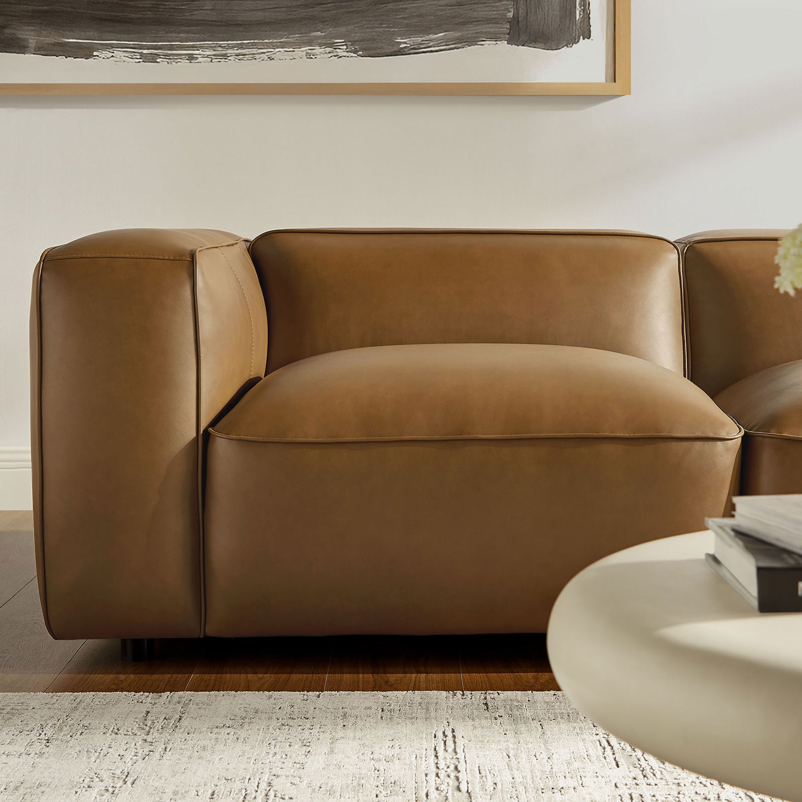 Plush camel vegan leather seat and arm with soft curves and tailored topstitching || EEI-7129-CAM || detail_room