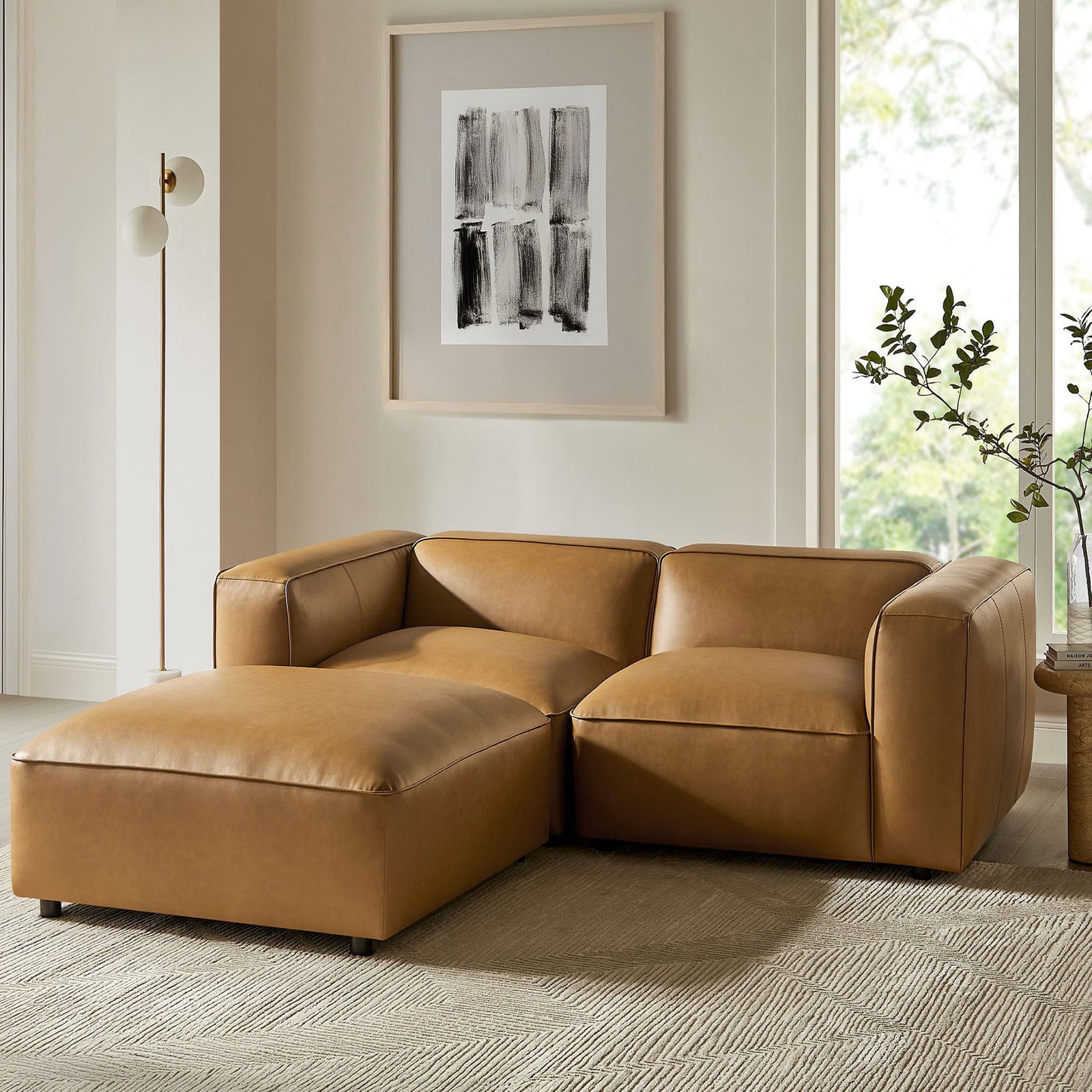 Camel modular loveseat with ottoman styled in a bright contemporary living room || EEI-7130-CAM || front_angle_room