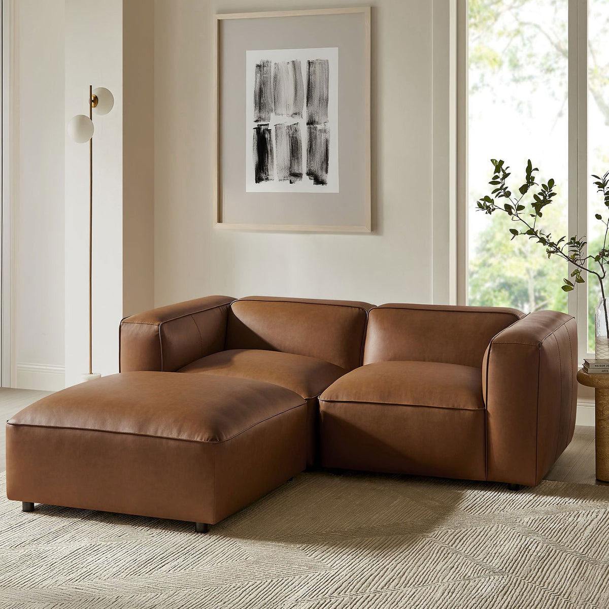 Coffee vegan leather modular loveseat with ottoman styled in a bright contemporary living room || EEI-7130-COF || front_angle_room