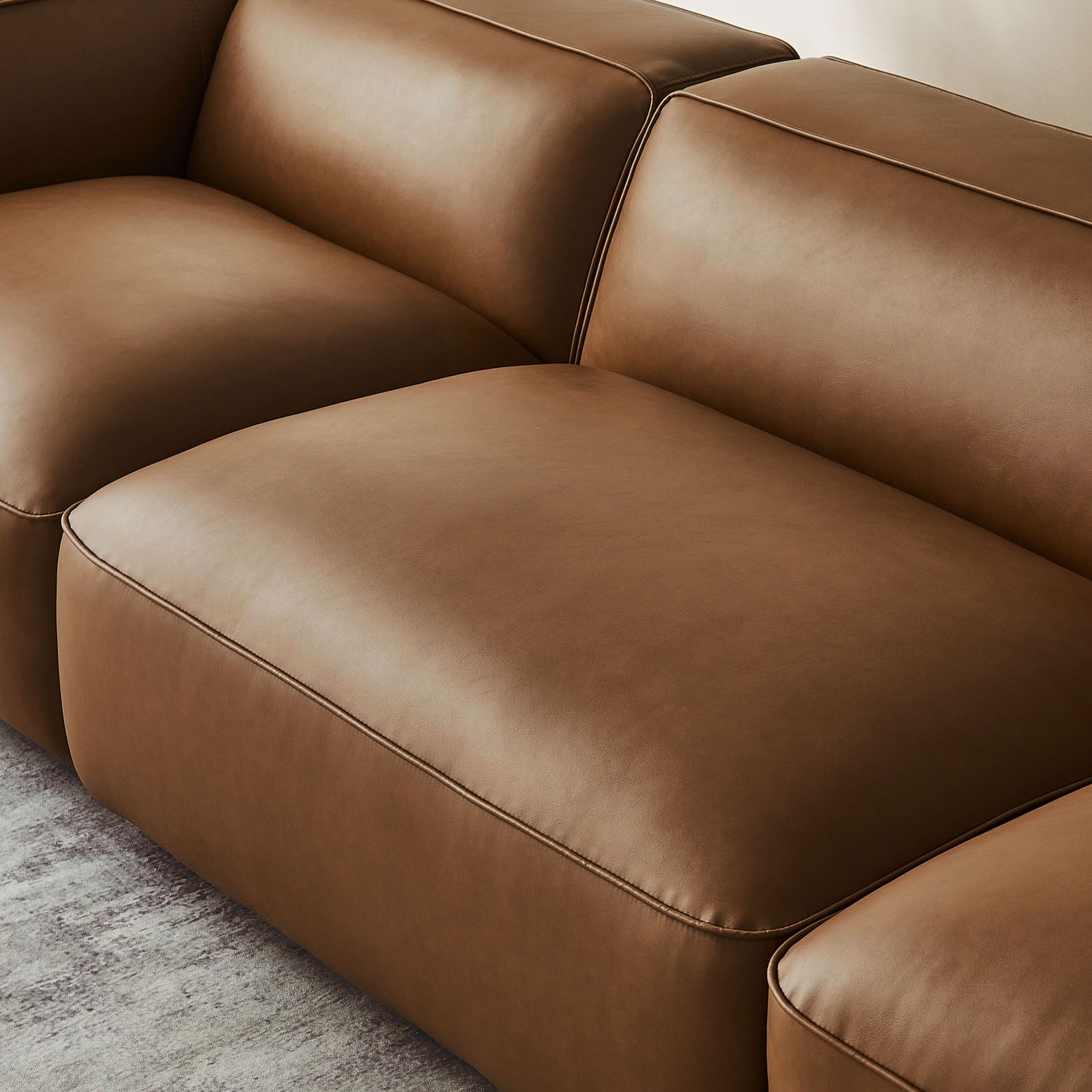 Detail of coffee vegan leather seat and back cushions highlighting generous foam padding || EEI-7132-COF || detail_room