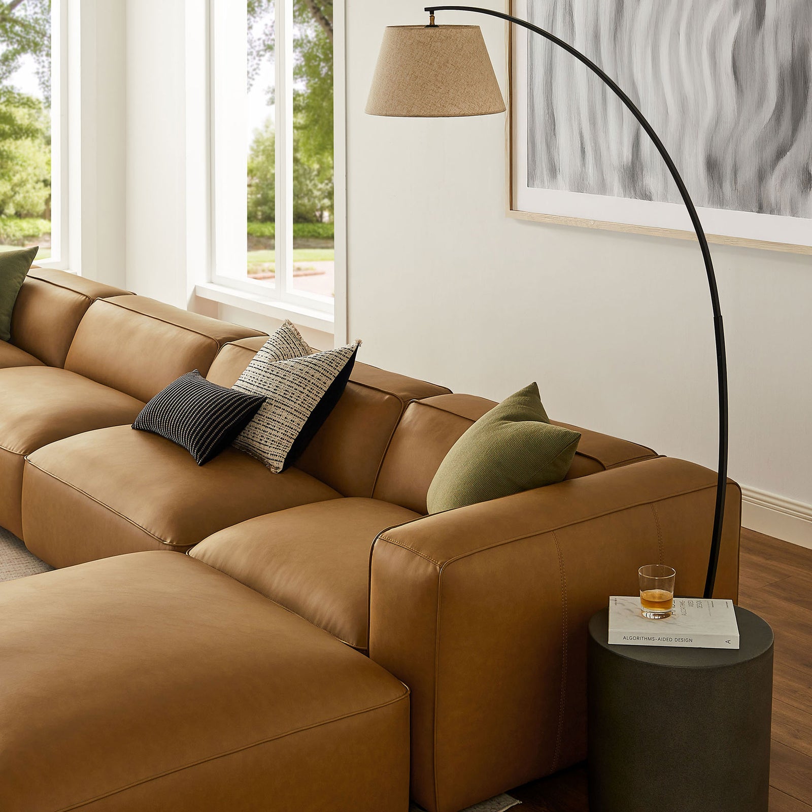Camel vegan leather Auren sectional with plush cushions styled beside a round side table || EEI-7134-CAM || detail_room