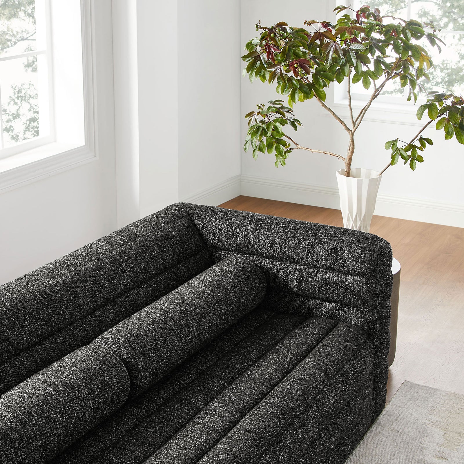 Relle sofa in a bright room highlighting its textured charcoal boucle and plush channel tufting || EEI-7136-CHA || detail_room
